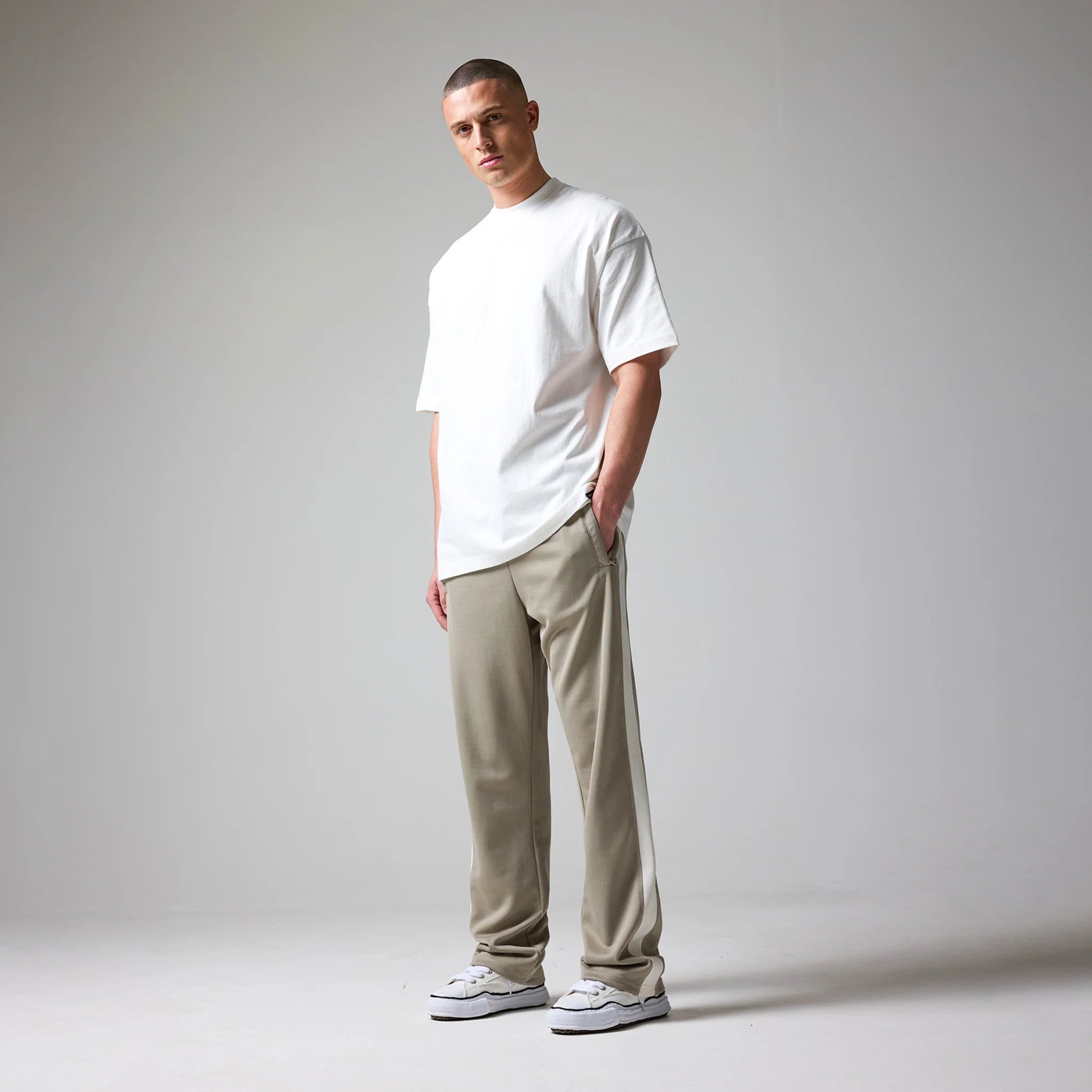 Pants worn by a person on a plain background