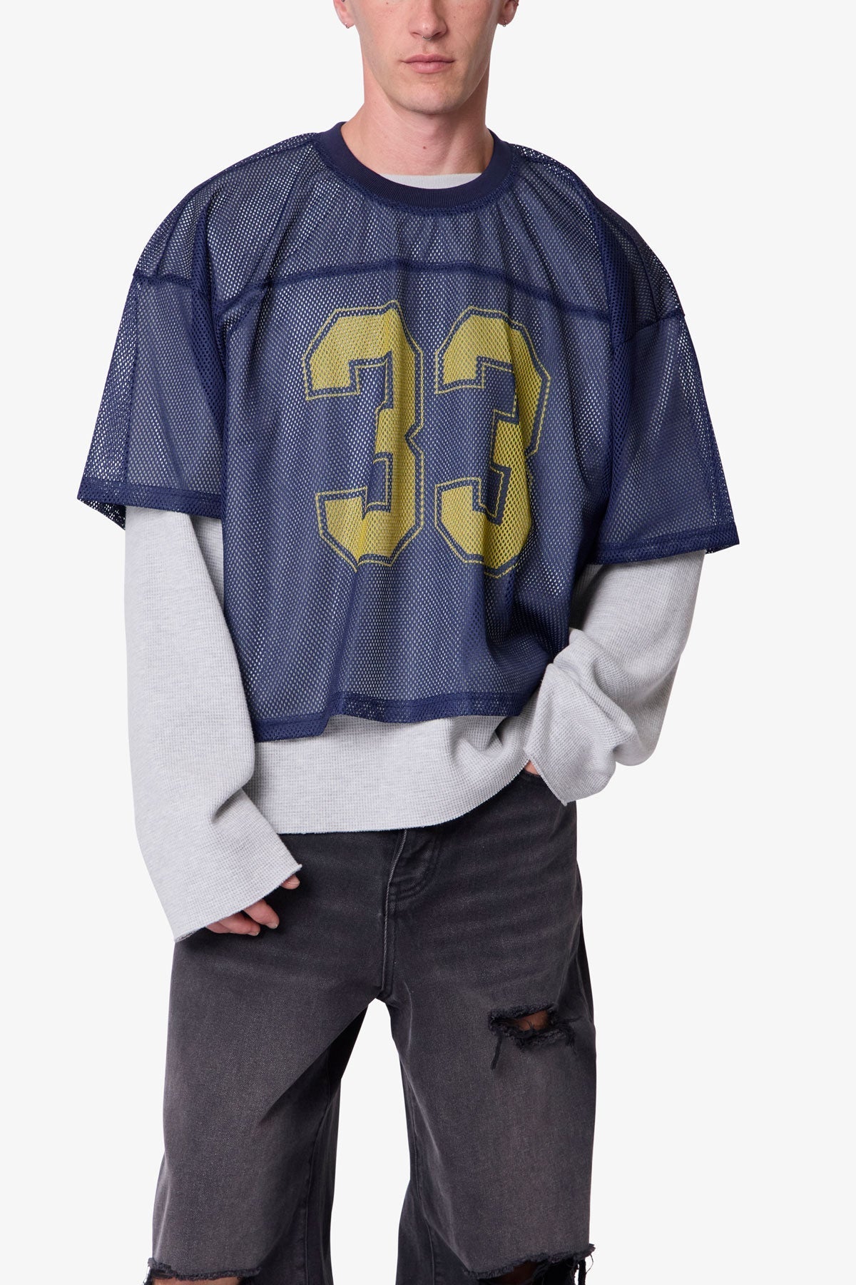 Person wearing a navy blue sports jersey with yellow number 33 on a white background