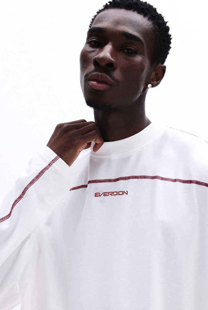 Man wearing a white shirt with red accents and 'Everdion' branding.