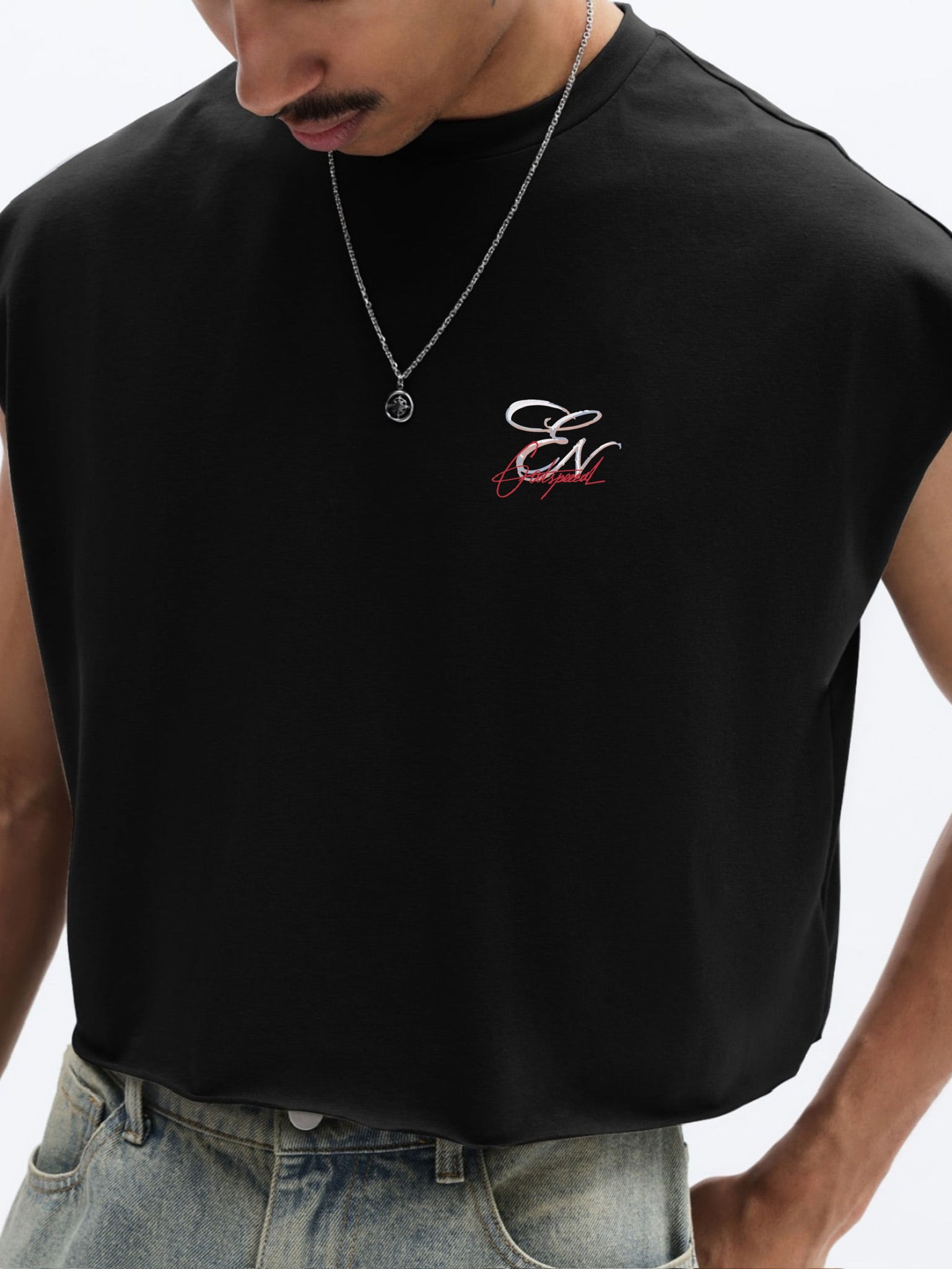 Person wearing a black sleeveless shirt with a logo on a white background