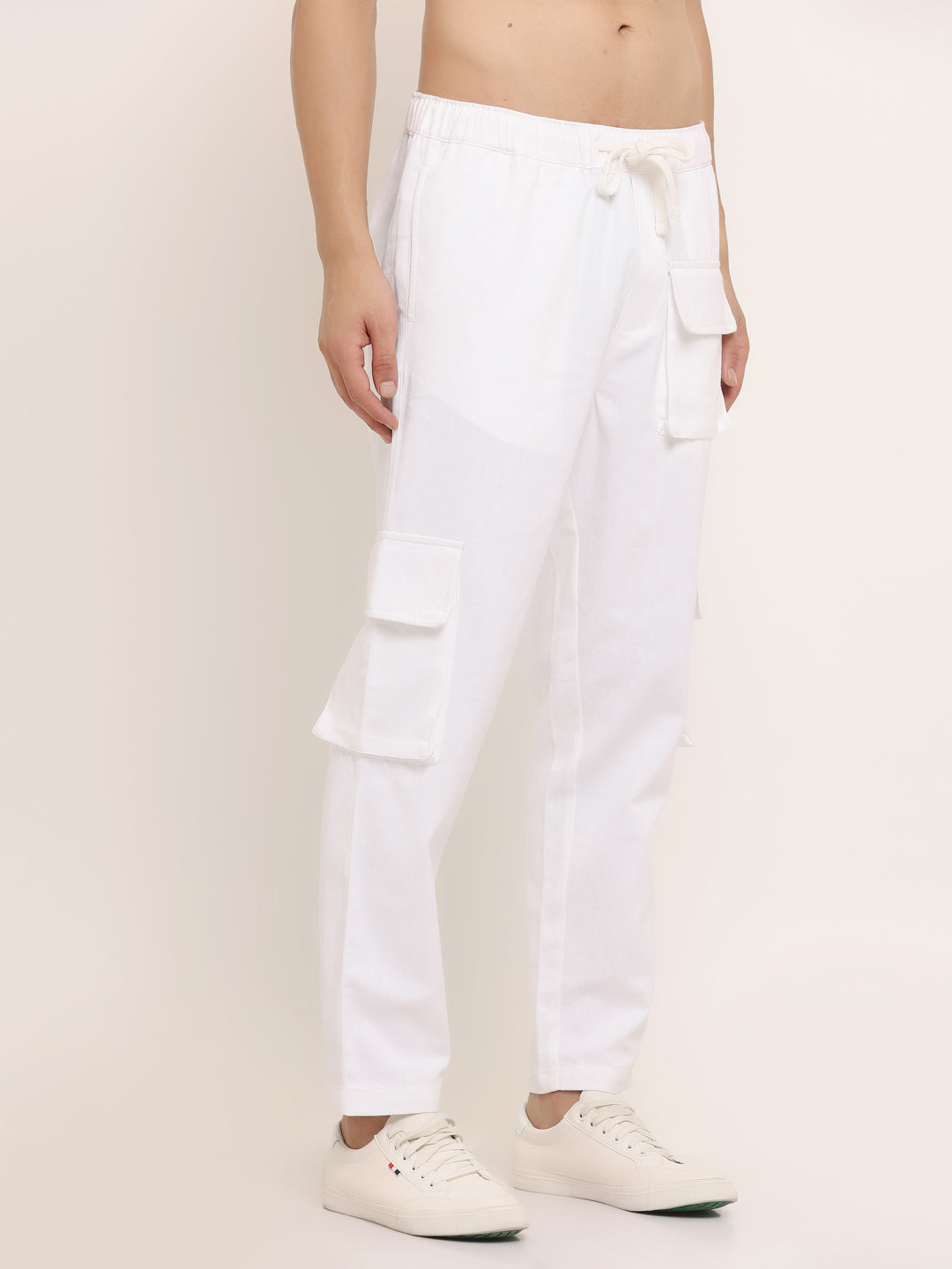 A white slim-fit cargo pants with multiple pockets, featuring an elasticated waistband with a drawstring.