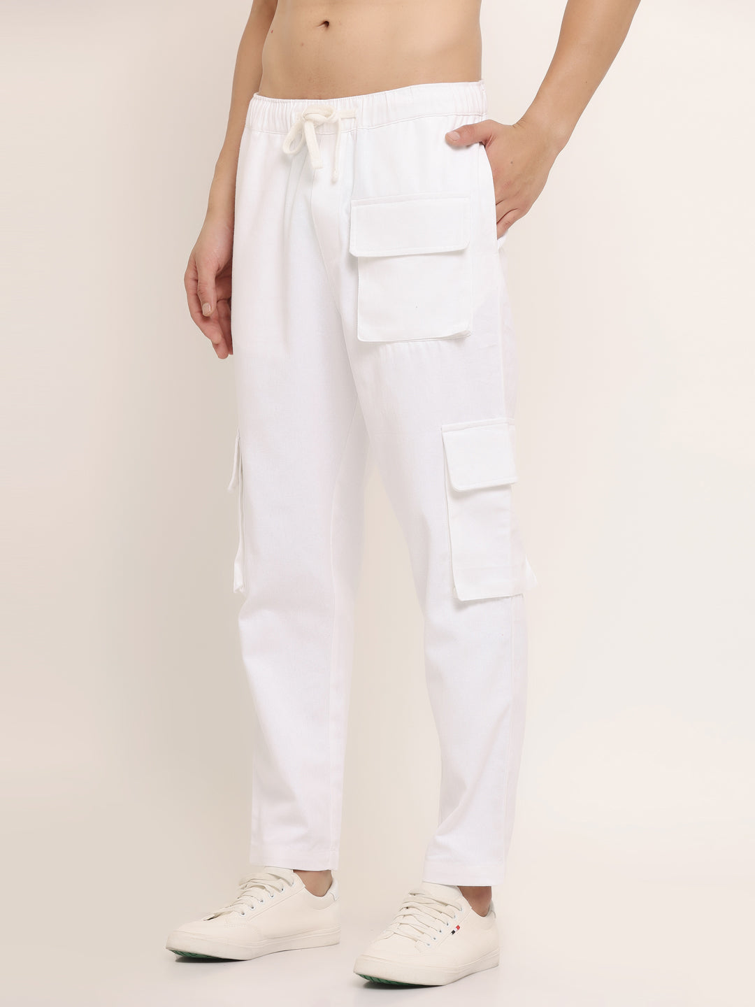 A white slim-fit cargo pants with multiple pockets, featuring an elasticated waistband with a drawstring.