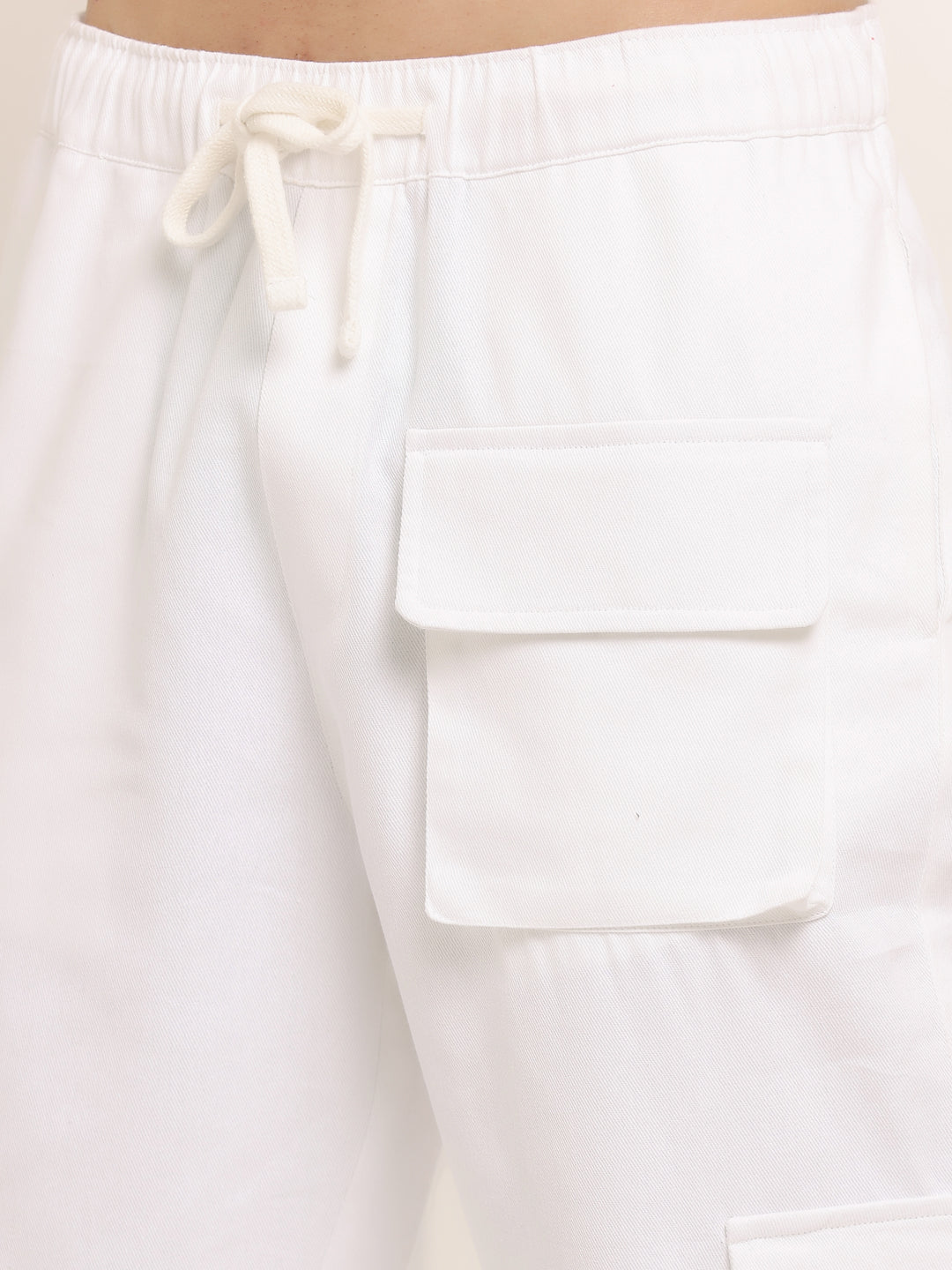 A white slim-fit cargo pants with multiple pockets, featuring an elasticated waistband with a drawstring.