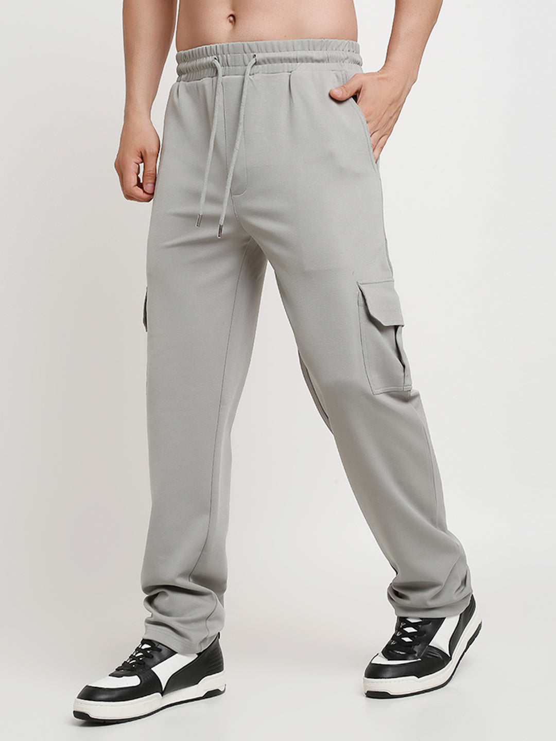 A model wearing grey slim fit cargo pants with large side flap pockets, designed for men.