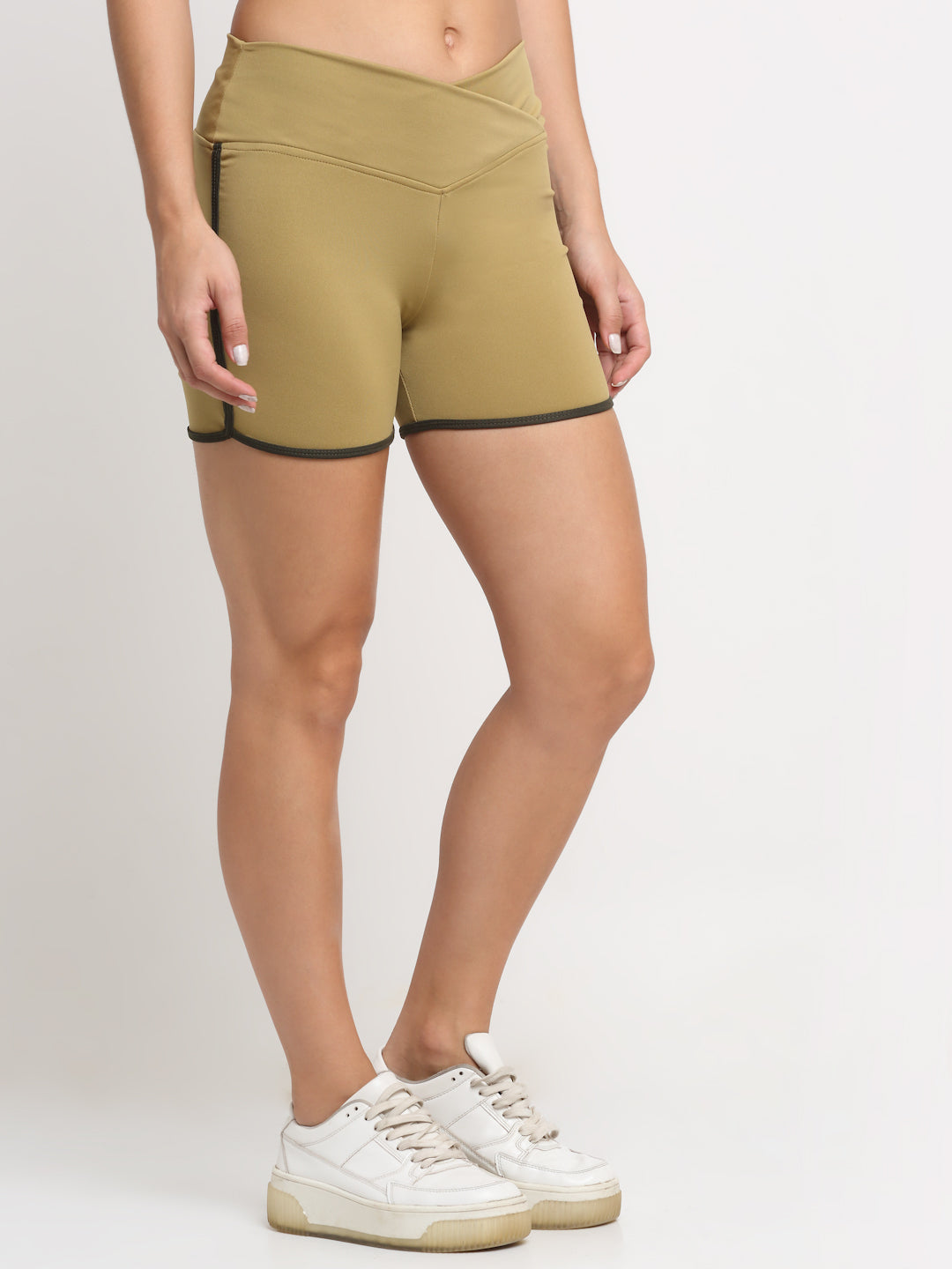 A pair of khaki active running shorts for women with contrasting piping on the sides.