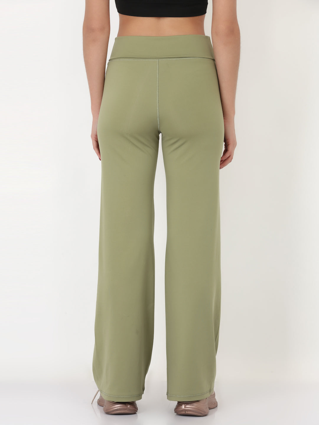 A pair of green flared high-rise full-length yoga pants on a female model.