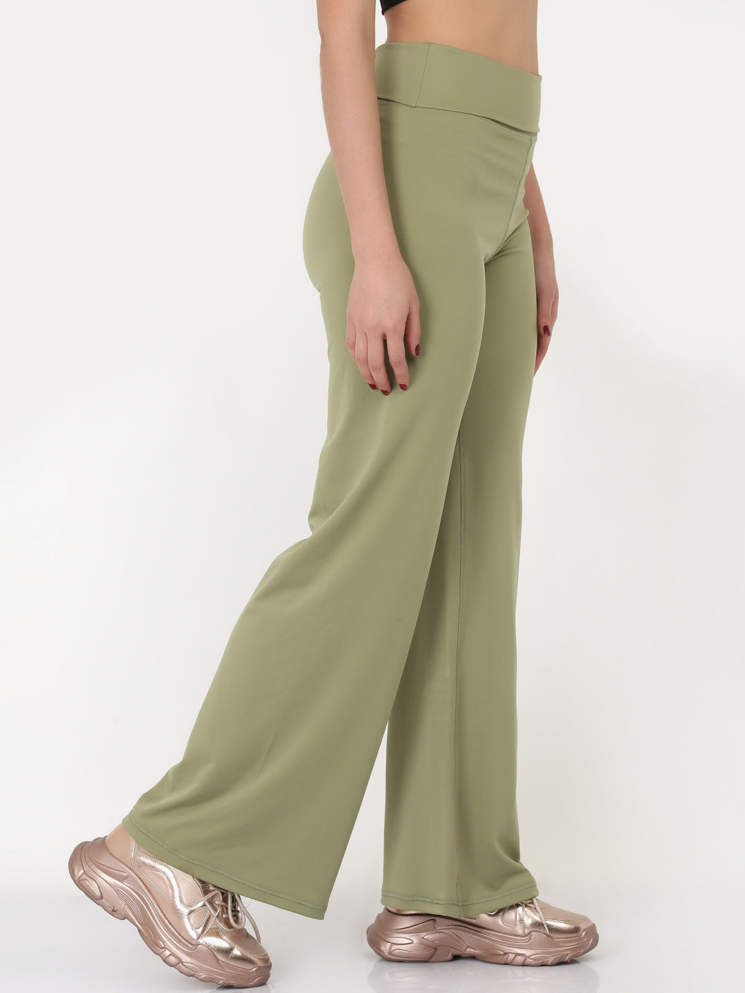 A pair of green flared high-rise full-length yoga pants on a female model.