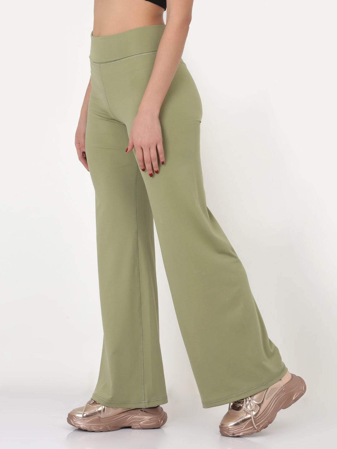 A pair of green flared high-rise full-length yoga pants on a female model.