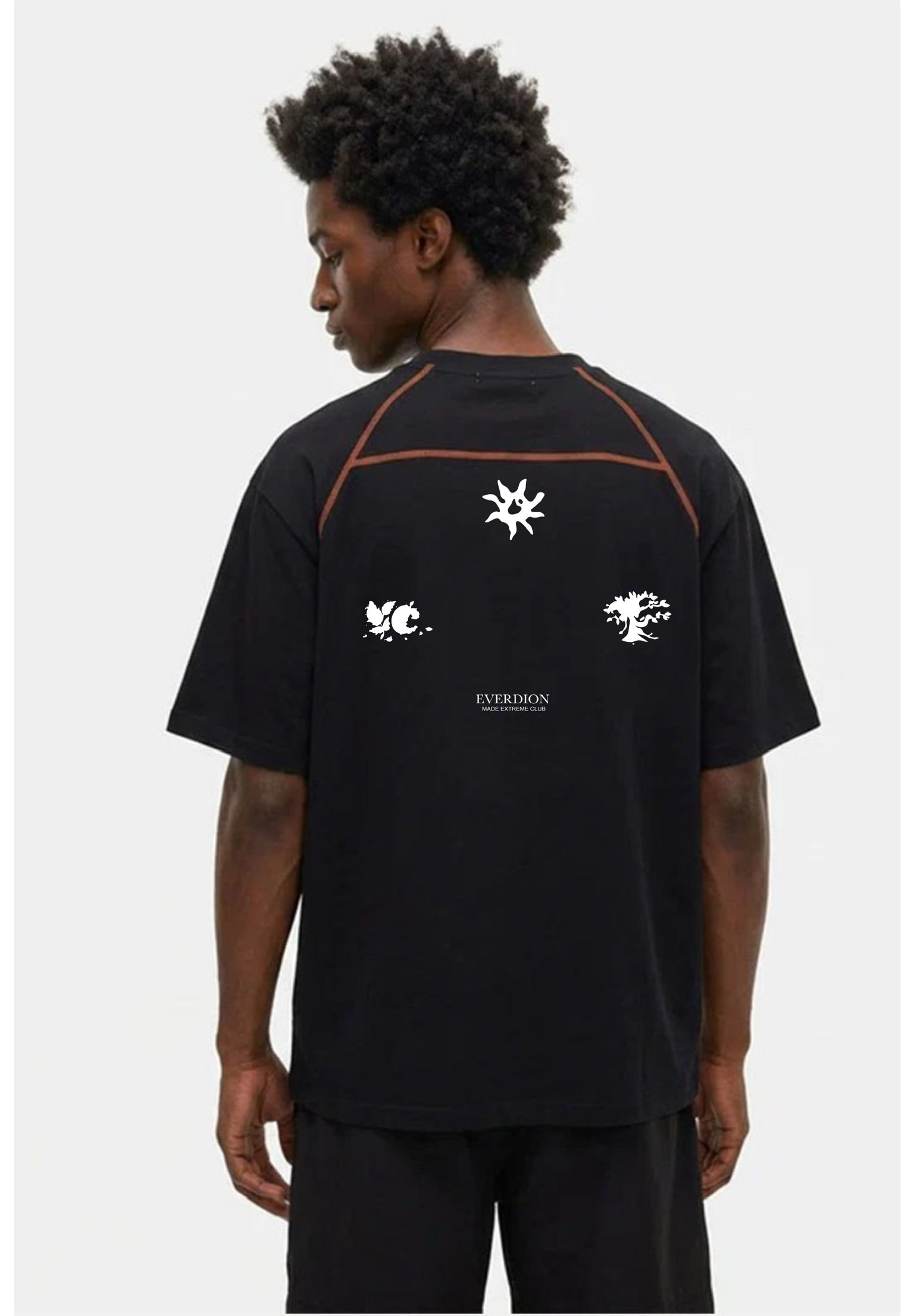 Person wearing a black t-shirt with graphics and text on the back against a white background
