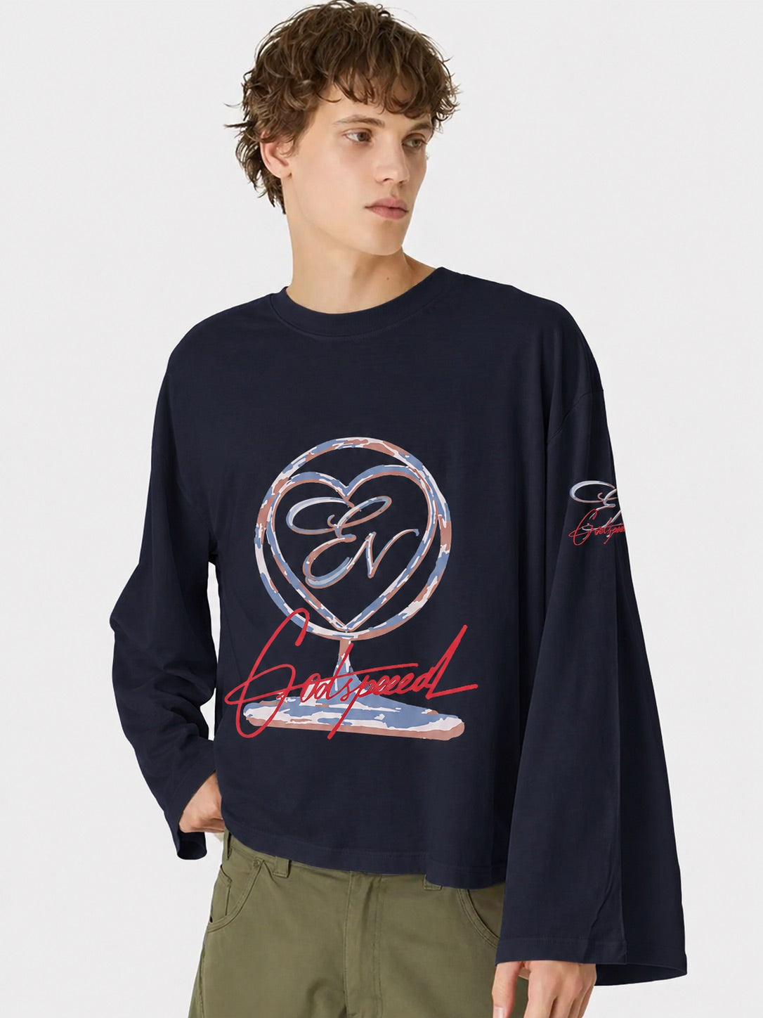 Person wearing a navy blue long-sleeve shirt with a heart-shaped logo and text on a plain background