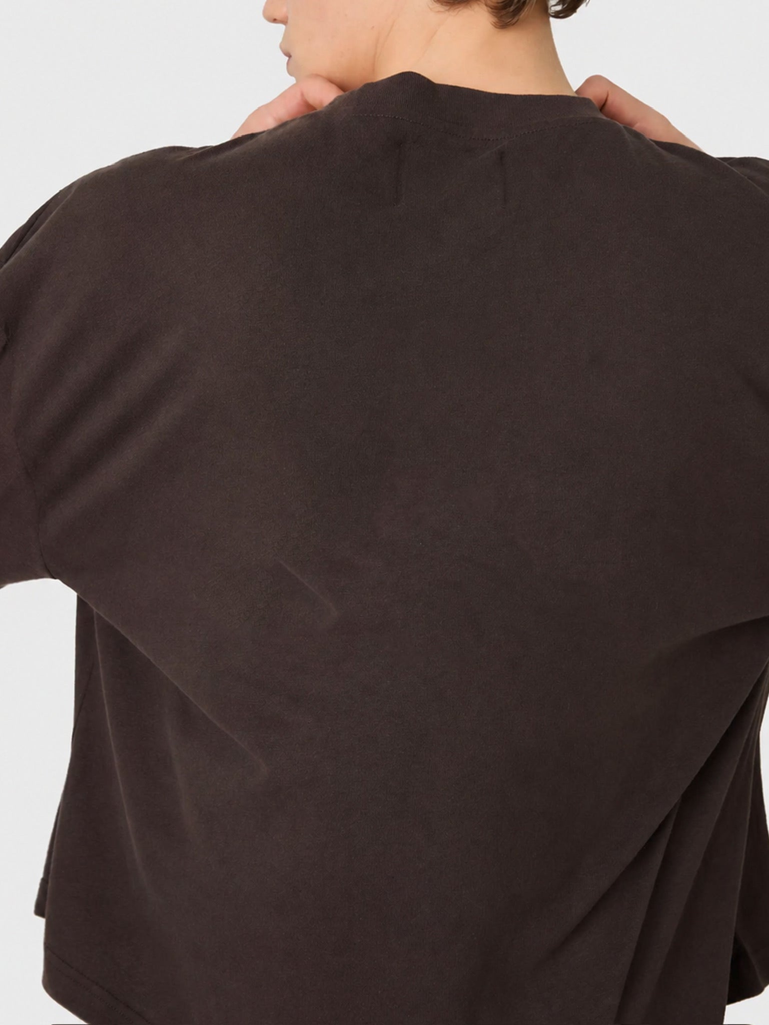 Brown jacket worn by a person on a light grey background