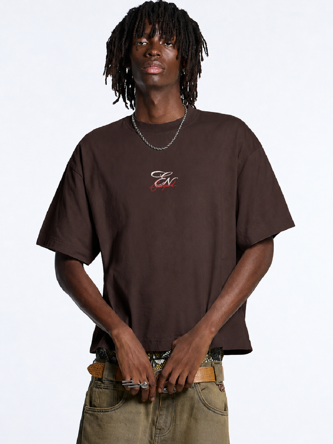 Person wearing a brown t-shirt with a logo on a white background