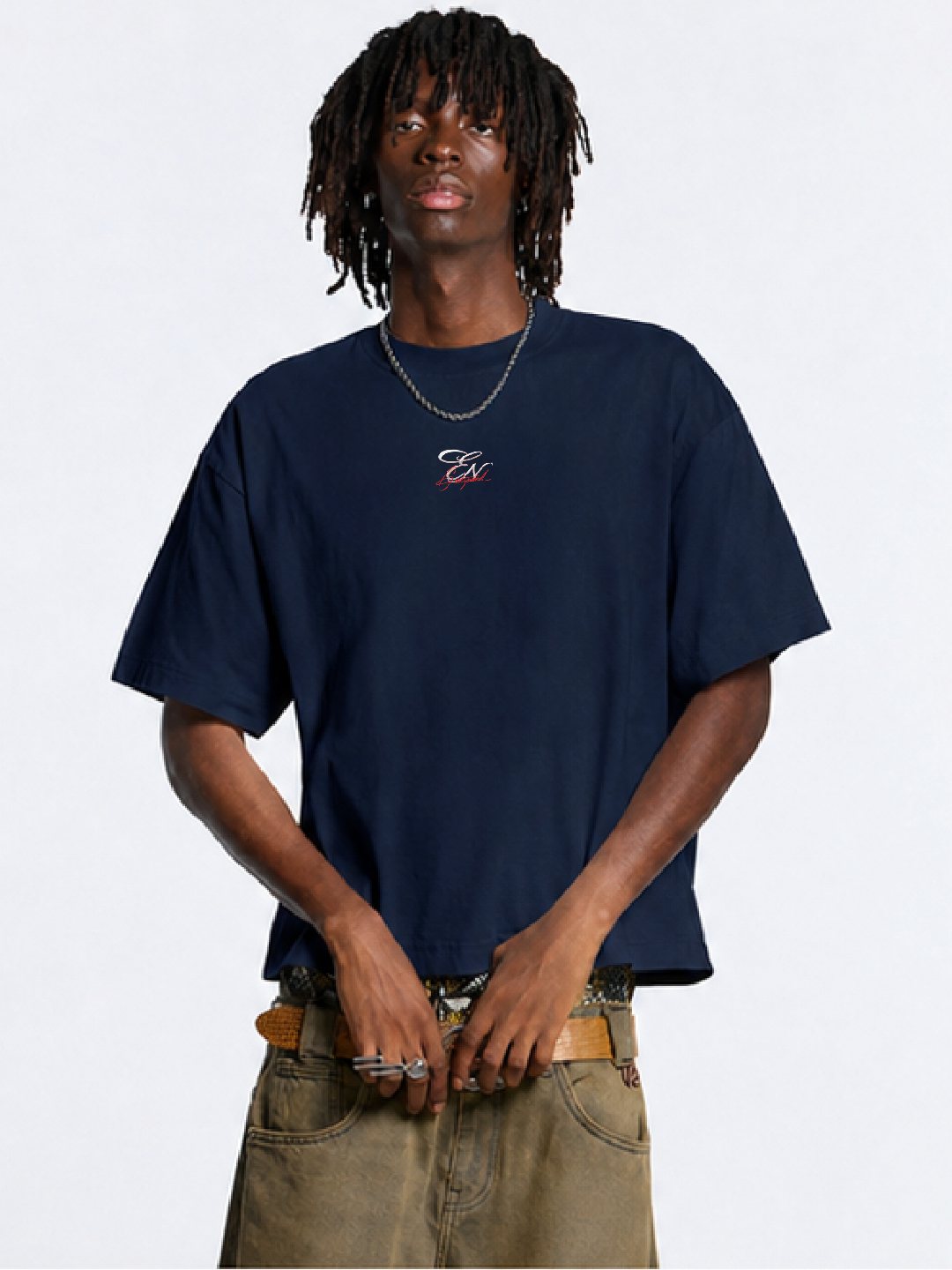 Person wearing a navy blue t-shirt with a logo on a white background
