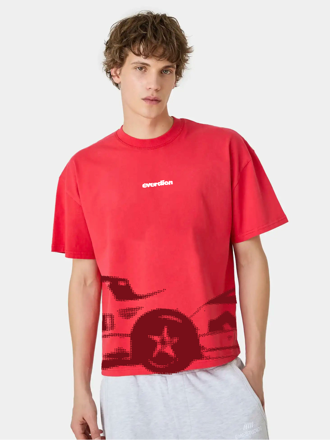 Person wearing a red t-shirt with a graphic design on a white background