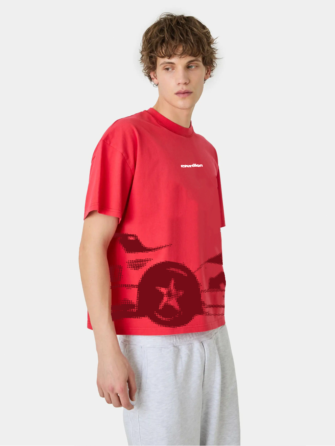 Person wearing a red t-shirt with a graphic design on a white background