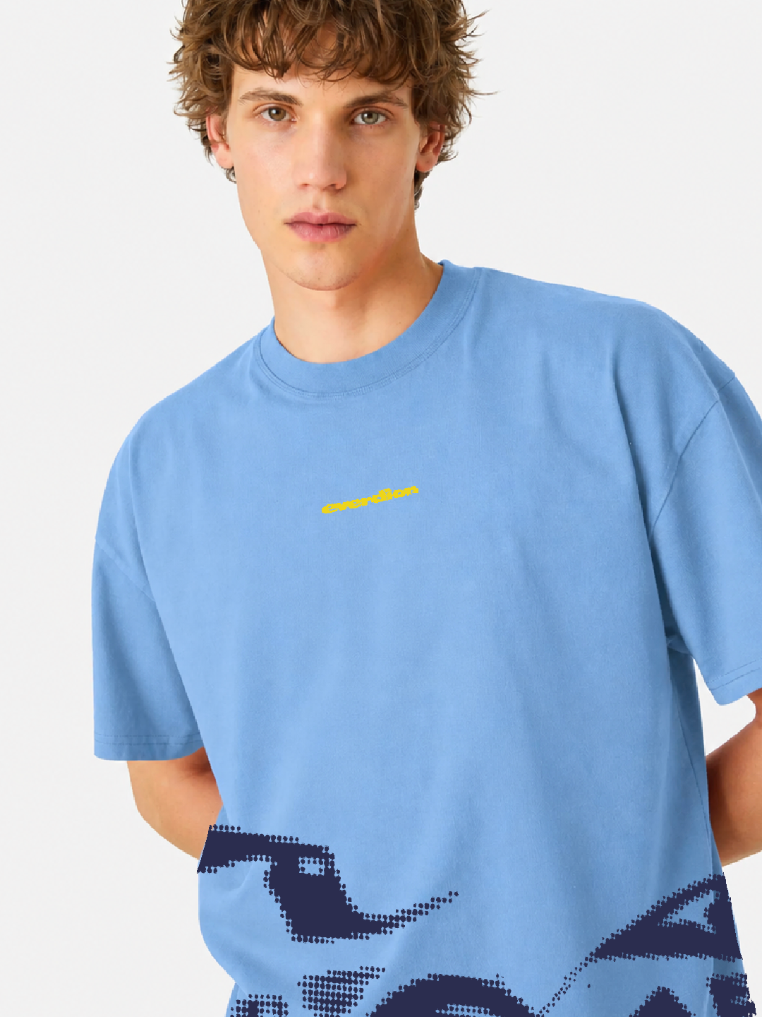 Man wearing a light blue t-shirt with a yellow logo on a white background