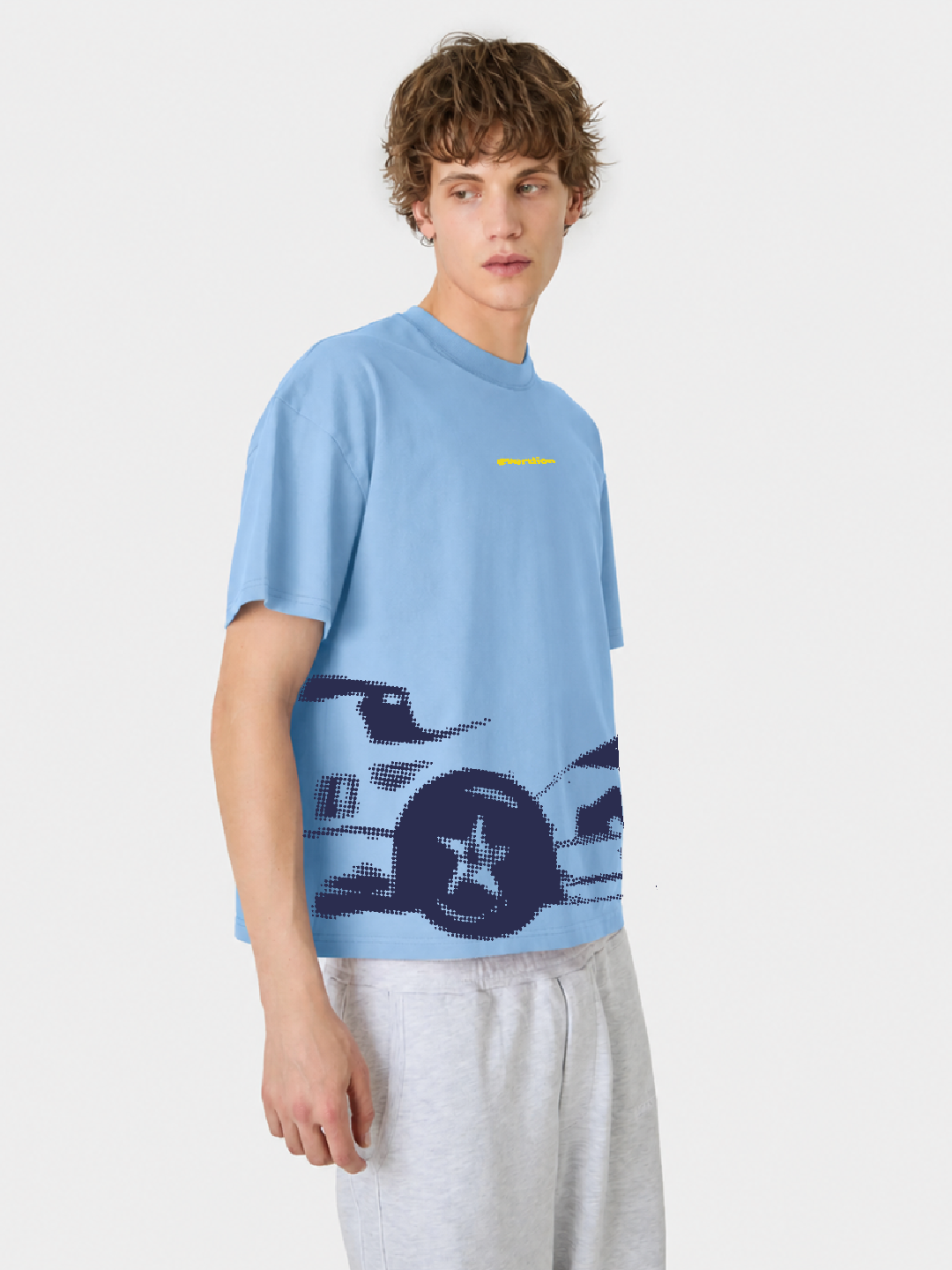 Person wearing a light blue t-shirt with a graphic design on a white background