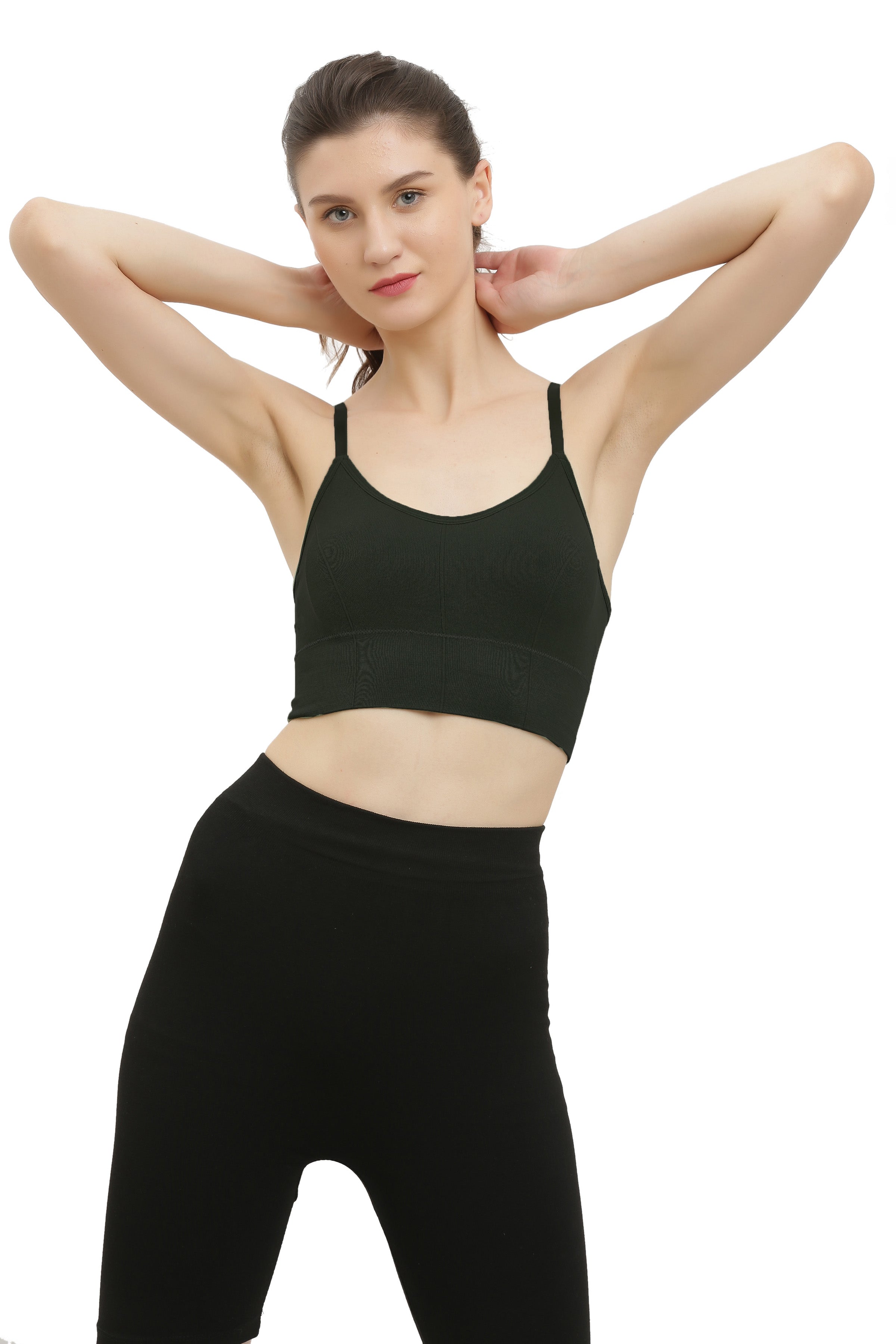 A woman modeling a black seamless padded sports bra with racerback style and spaghetti straps.
