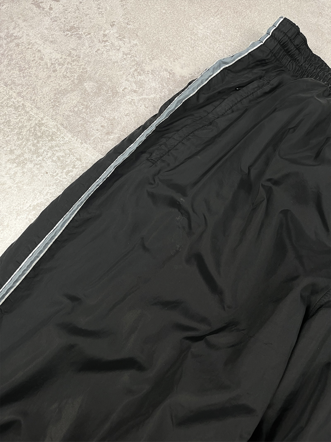 Close-up of a black suitcase with a zipper on a white background