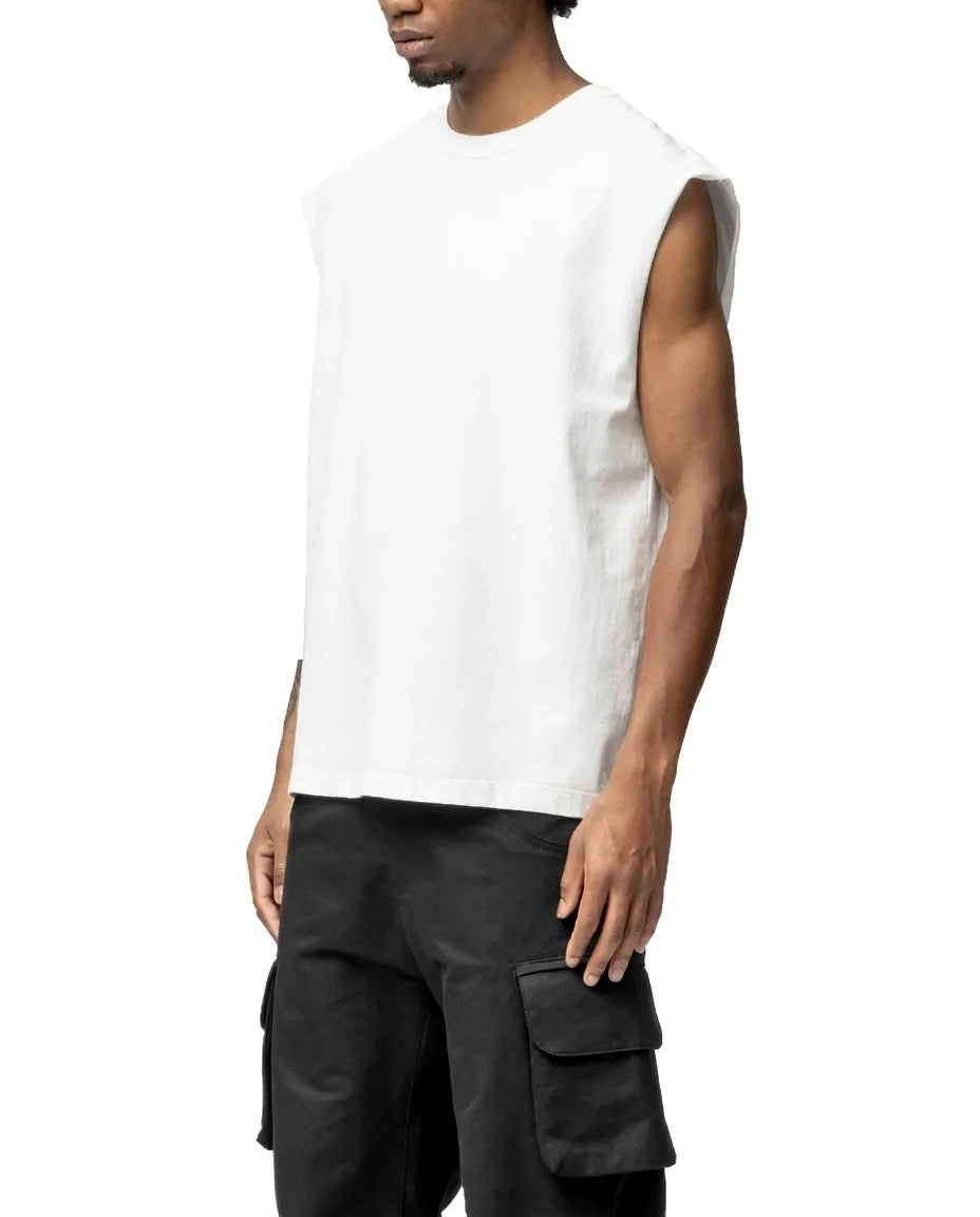 Person wearing a white sleeveless shirt and black cargo pants on a white background