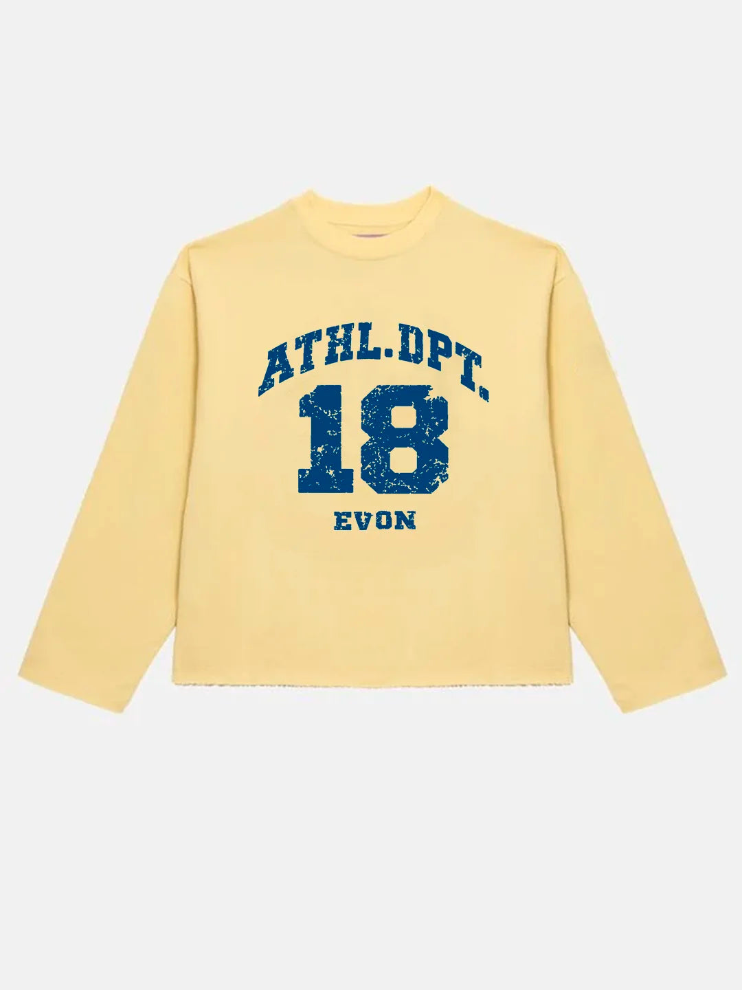 A pale yellow long-sleeve crewneck t-shirt with a distressed blue varsity-style graphic on the front reading 'ATHL.DPT.