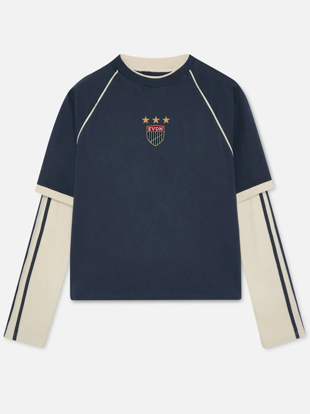 A navy blue long-sleeve crewneck sweatshirt with cream-colored raglan sleeves and collar, featuring a small USA crest with three stars on the chest and double stripe detailing on the sleeves