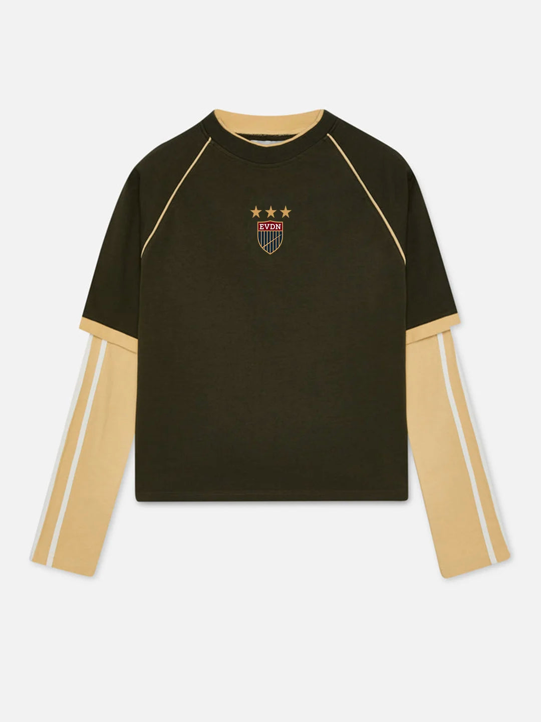 A dark olive green long-sleeve crewneck t-shirt with beige contrast panels on the sleeves and collar, featuring a small embroidered shield crest with three stars on the chest.