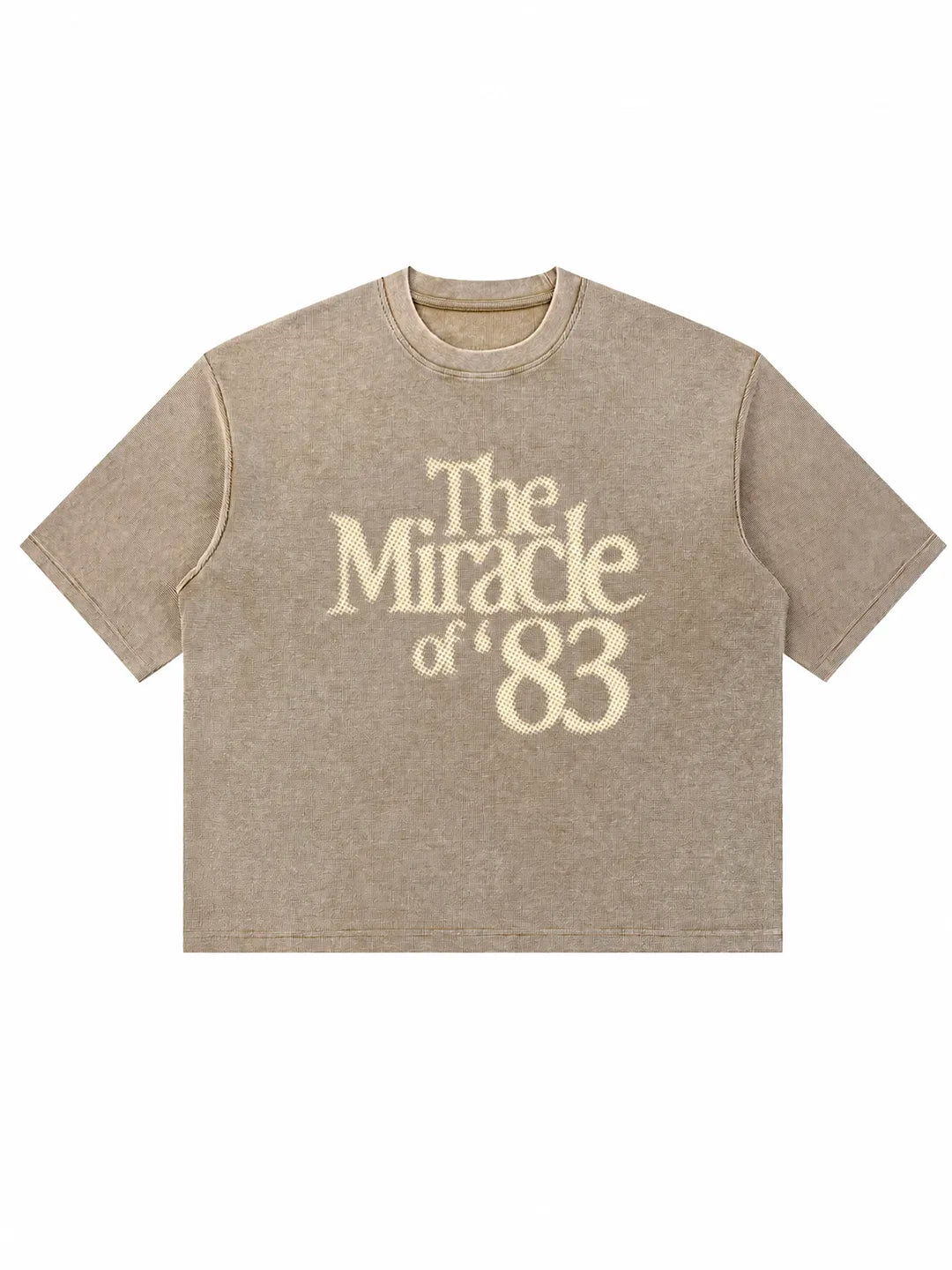 A beige short-sleeve t-shirt with a faded cream-colored graphic print reading 'The Miracle of '83' on the front, displayed against a solid white background.