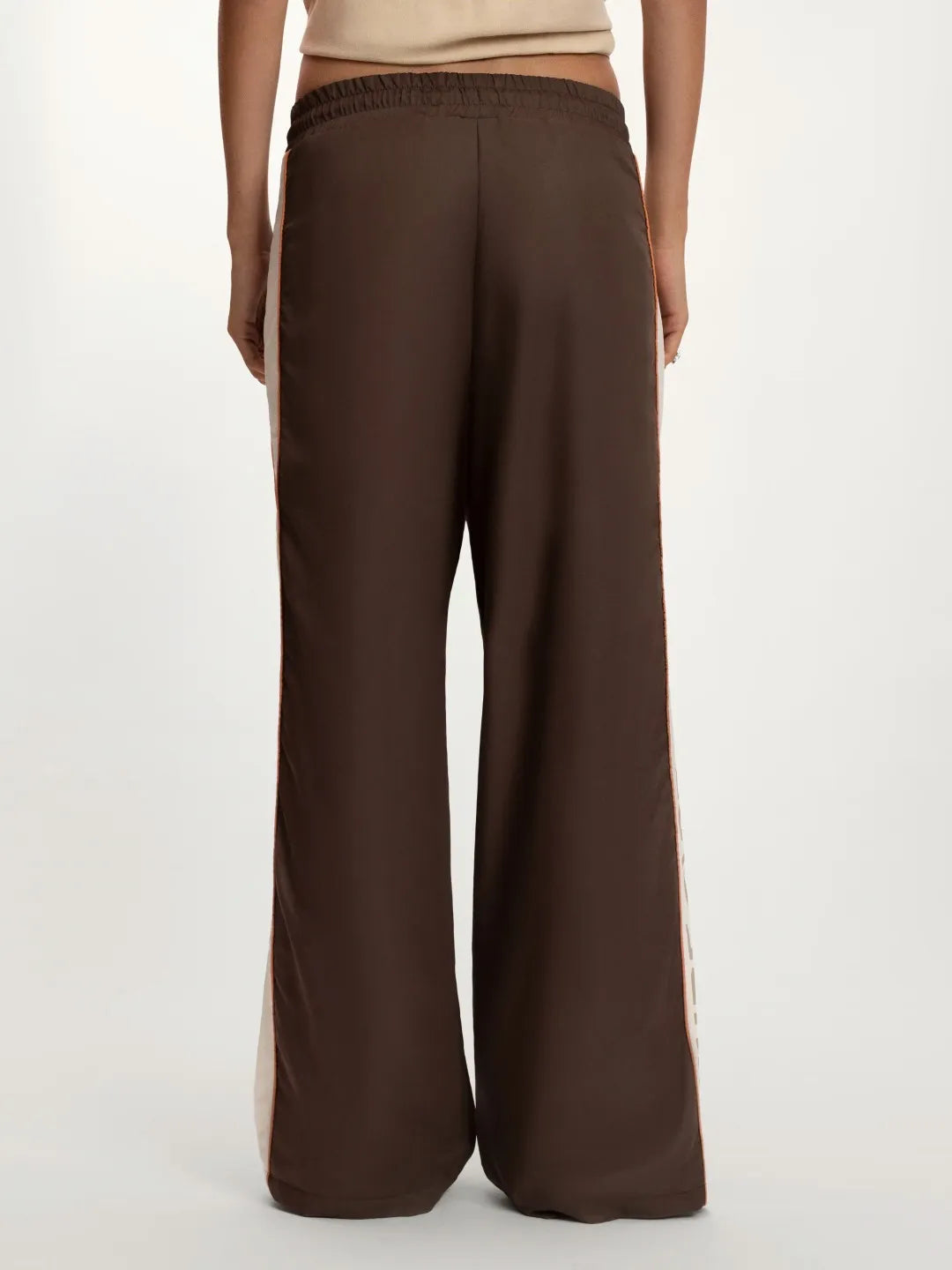 Brown wide-leg pants worn by a person on a white background