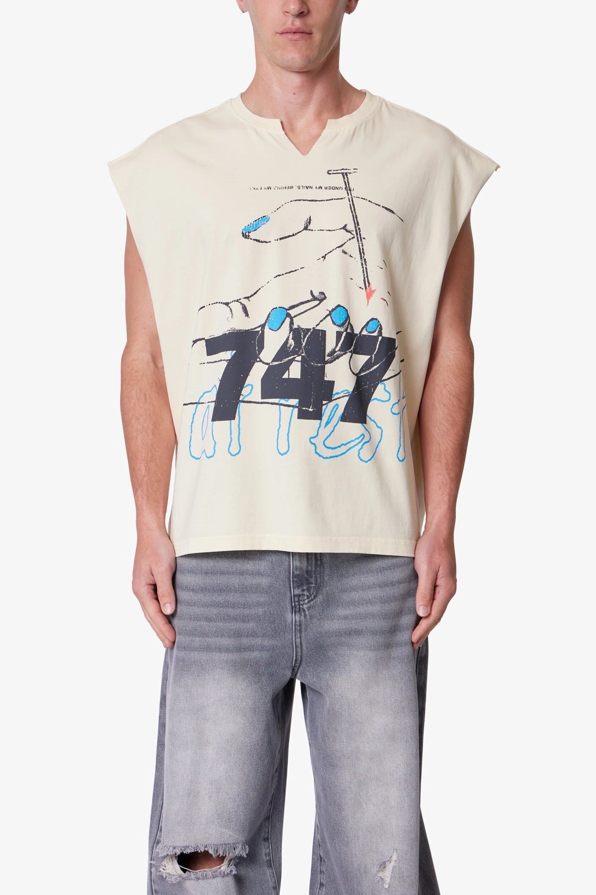 Men’s beige sleeveless printed tank top with notched crew neck, oversized fit, and bold distressed streetwear print