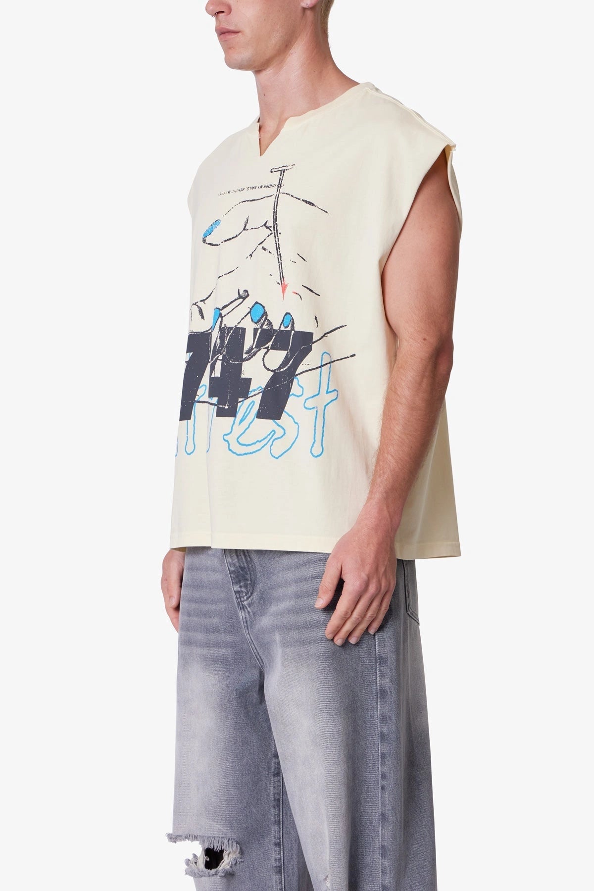 Side of Men’s beige sleeveless printed tank top with notched crew neck, oversized fit, and bold distressed streetwear print