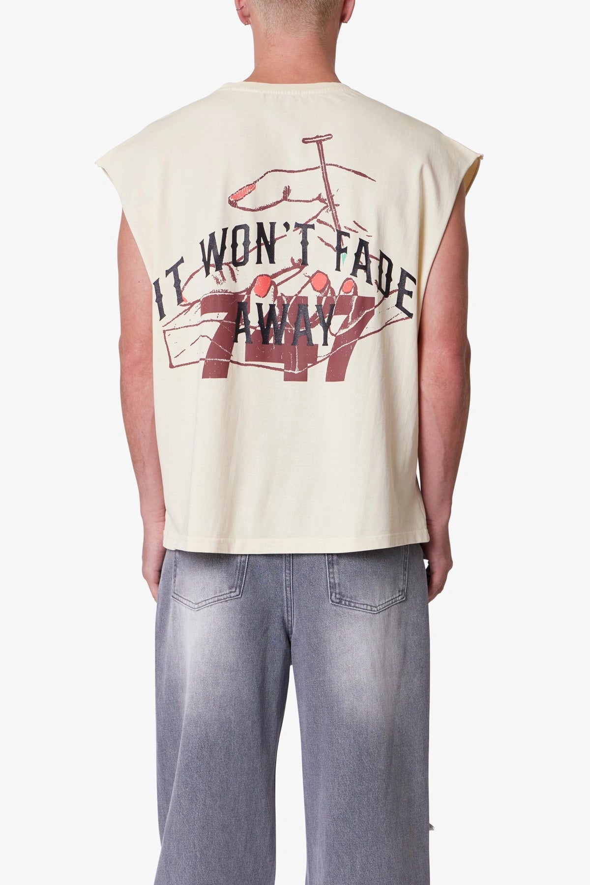 Men’s beige sleeveless printed tank top with notched crew neck, oversized fit, and bold distressed streetwear print