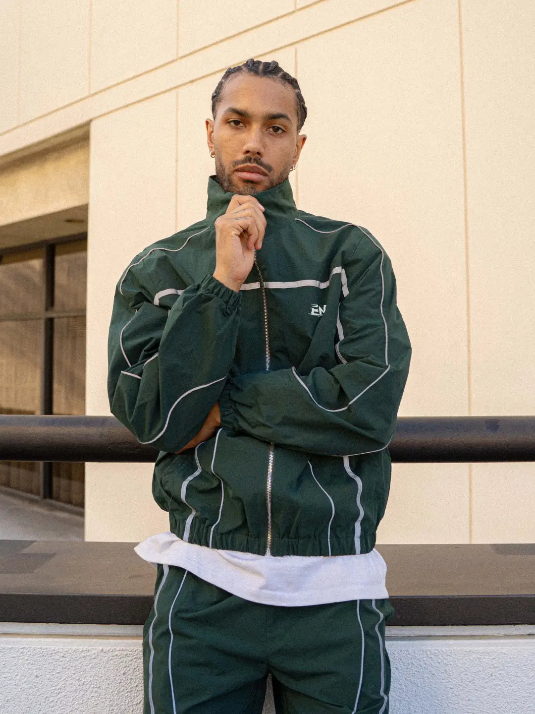 The Forest Green Jacket delivers a structured yet lightweight feel, while the relaxed-fit track pants ensure fluid movement and all-day comfort. 