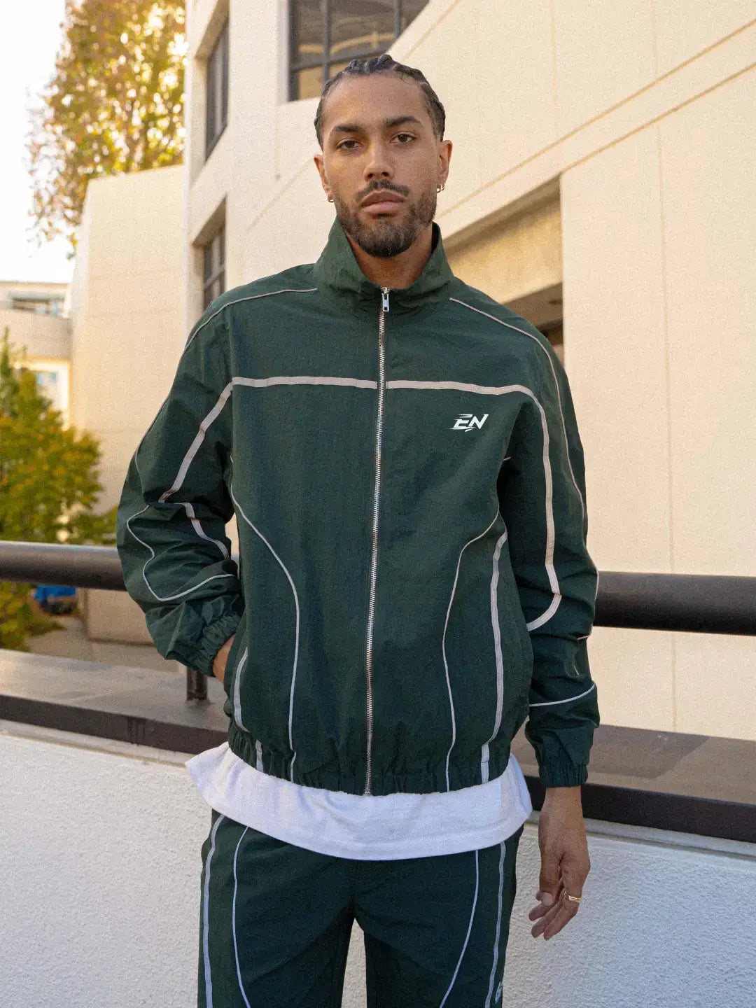 The Forest Green Jacket delivers a structured yet lightweight feel, while the relaxed-fit track pants ensure fluid movement and all-day comfort. 