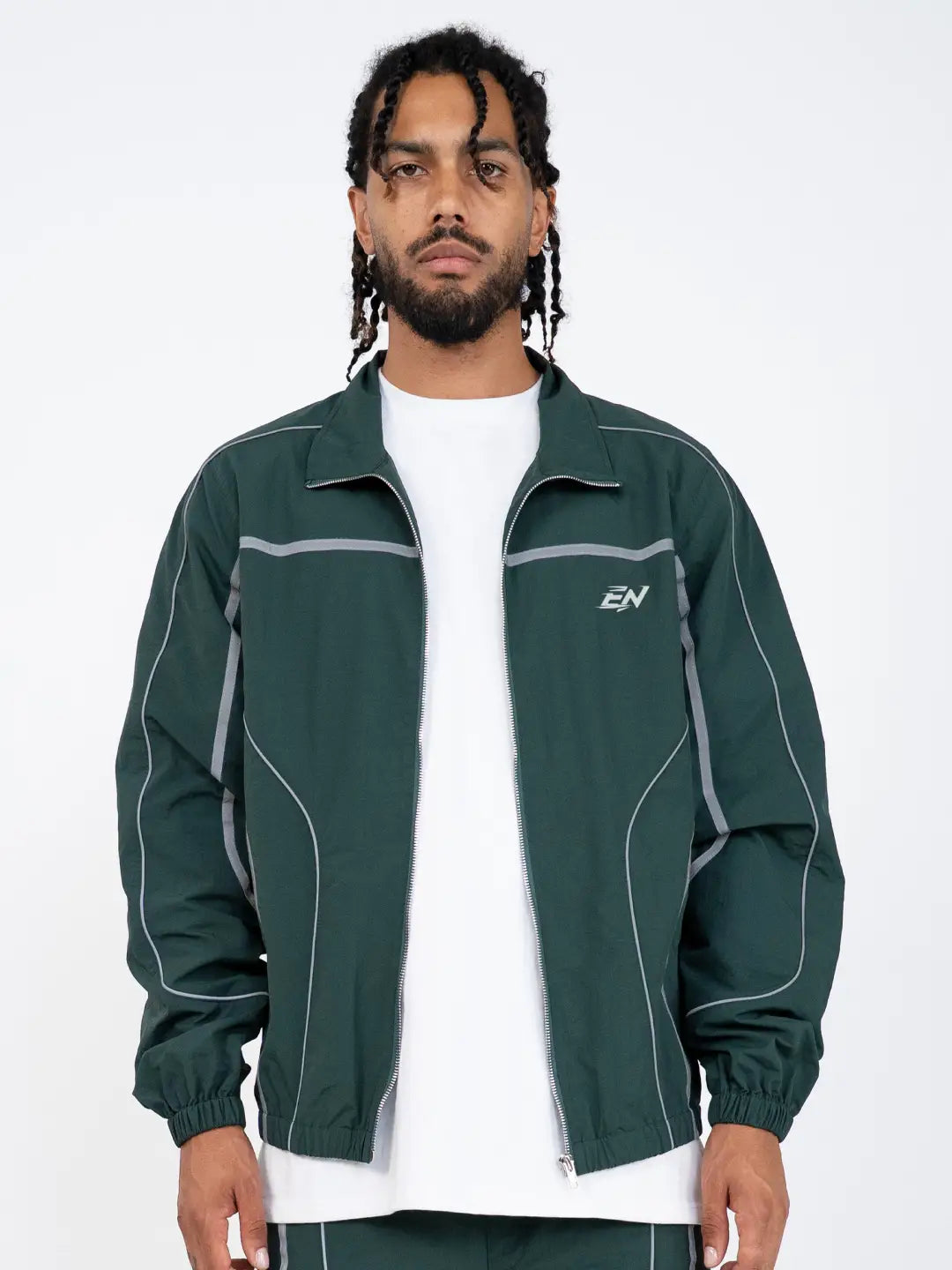 The Forest Green Jacket delivers a structured yet lightweight feel, while the relaxed-fit track pants ensure fluid movement and all-day comfort. 