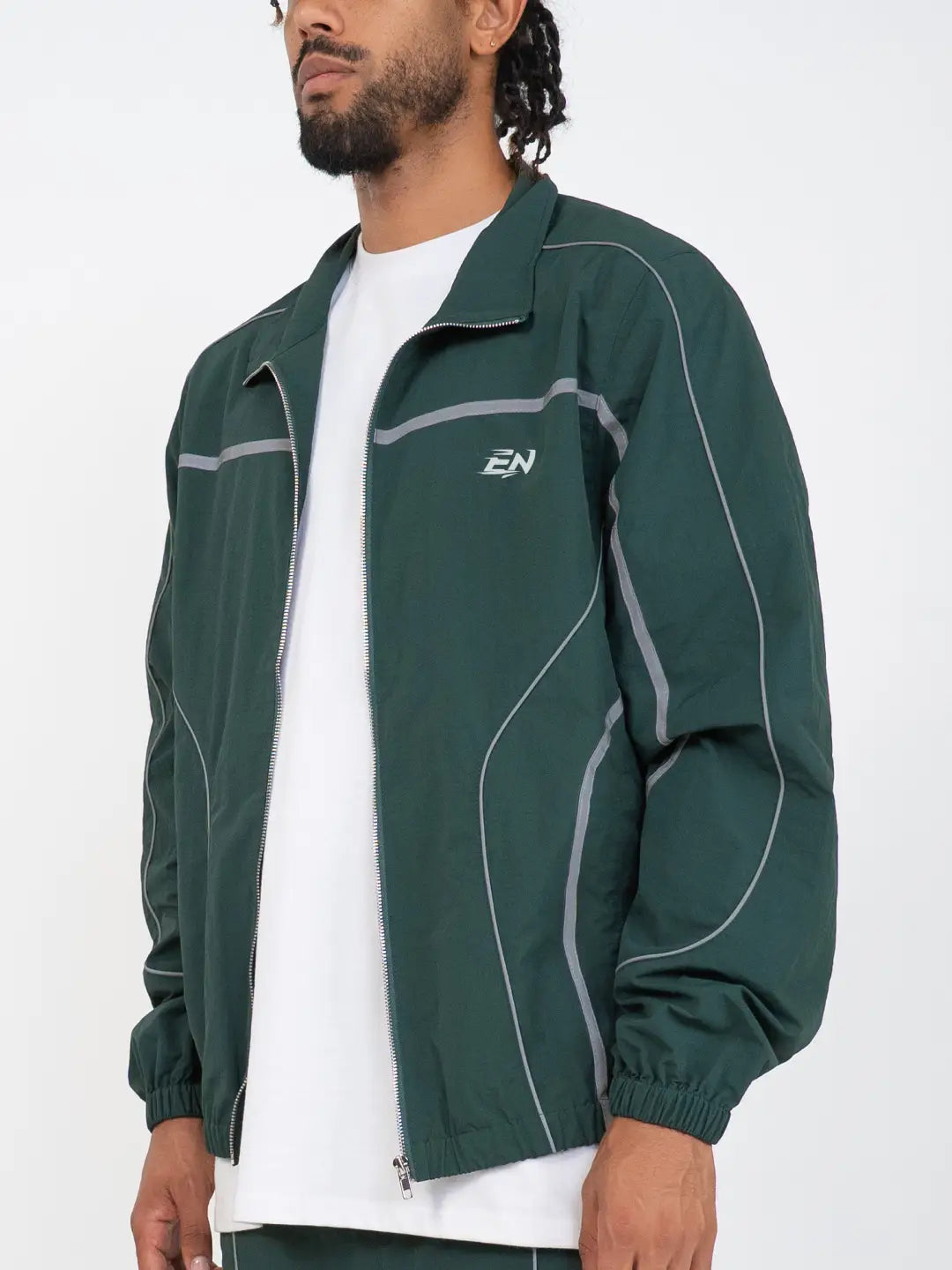 The Forest Green Jacket delivers a structured yet lightweight feel, while the relaxed-fit track pants ensure fluid movement and all-day comfort. 