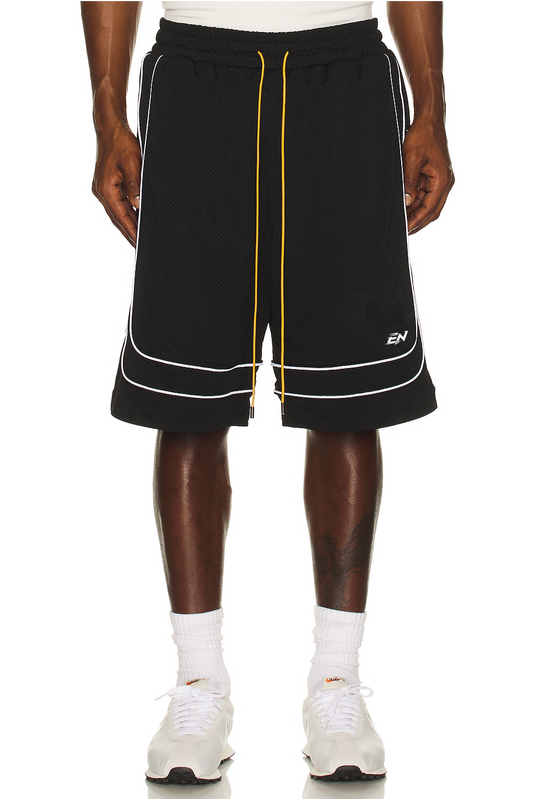 Black shorts with white and yellow accents worn by a person on a white background