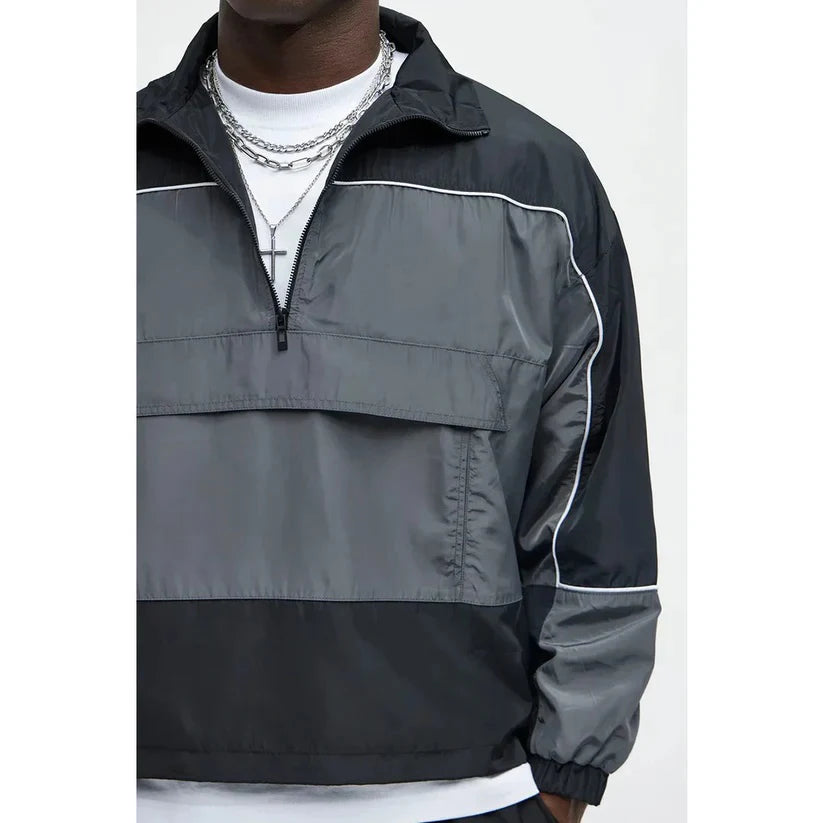 Black and gray half-zip jacket on a white background