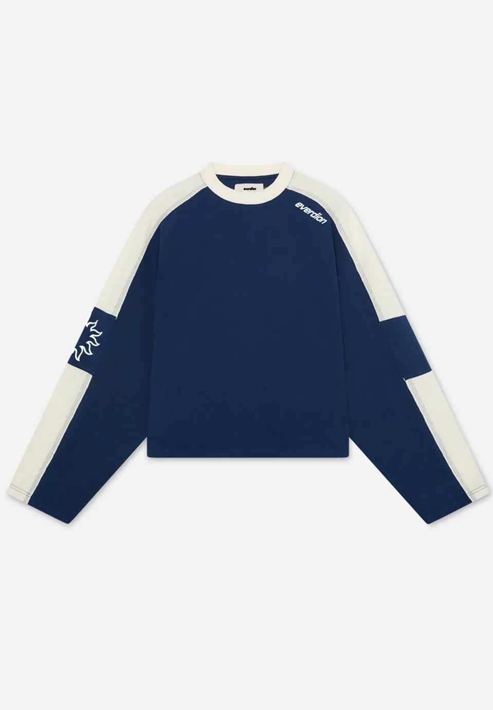 A long-sleeve crewneck t-shirt by Kith, featuring a navy blue body with contrasting cream-colored shoulder and sleeve panels, and white brand logos printed on the chest and sleeve.