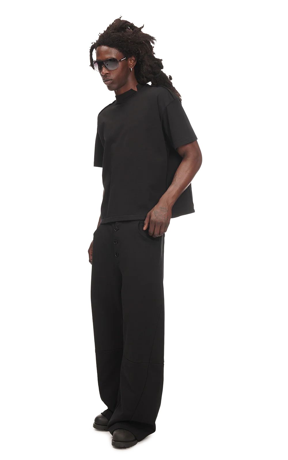 Man wearing a black outfit on a white background