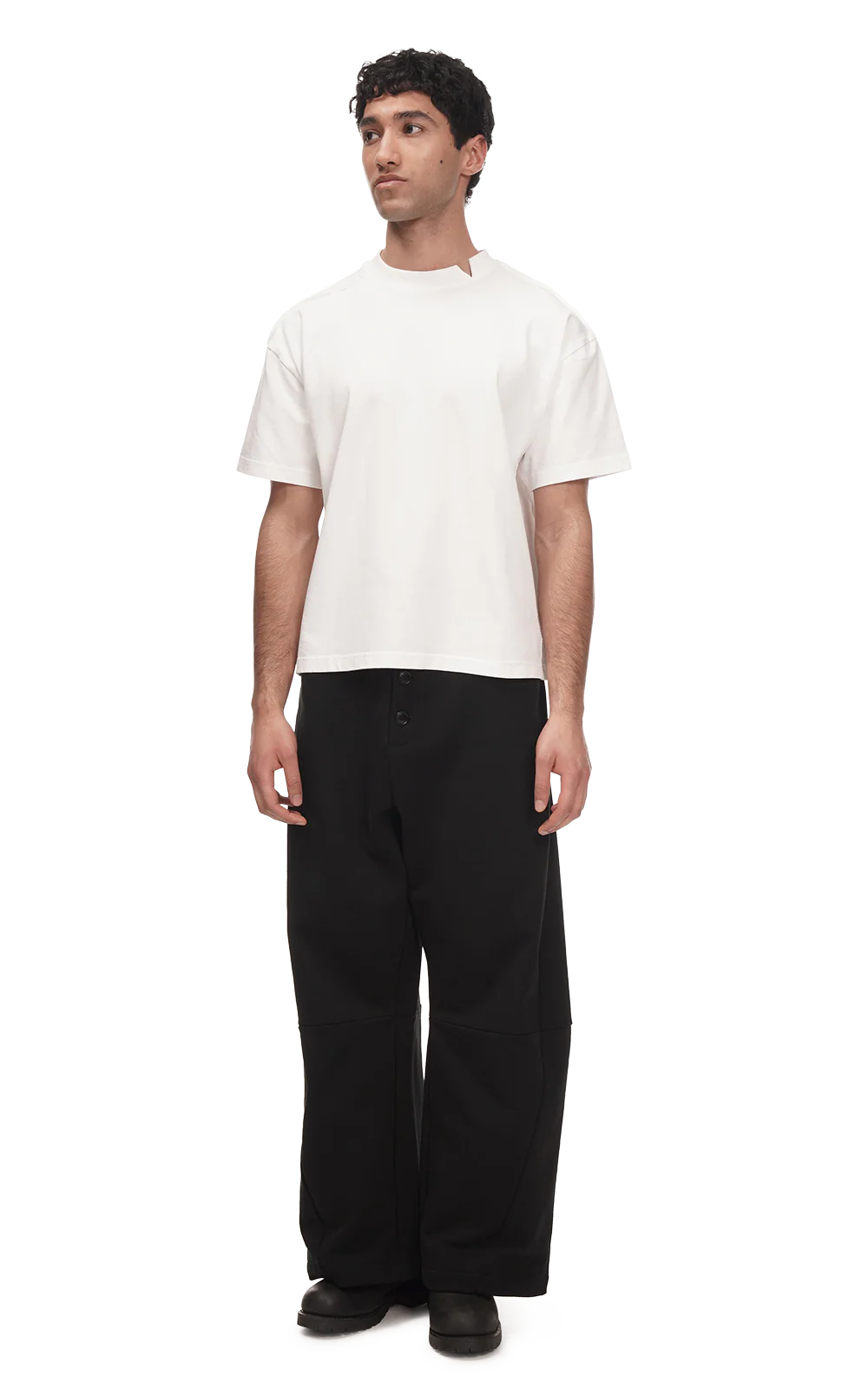Person wearing a white t-shirt and black pants on a white background