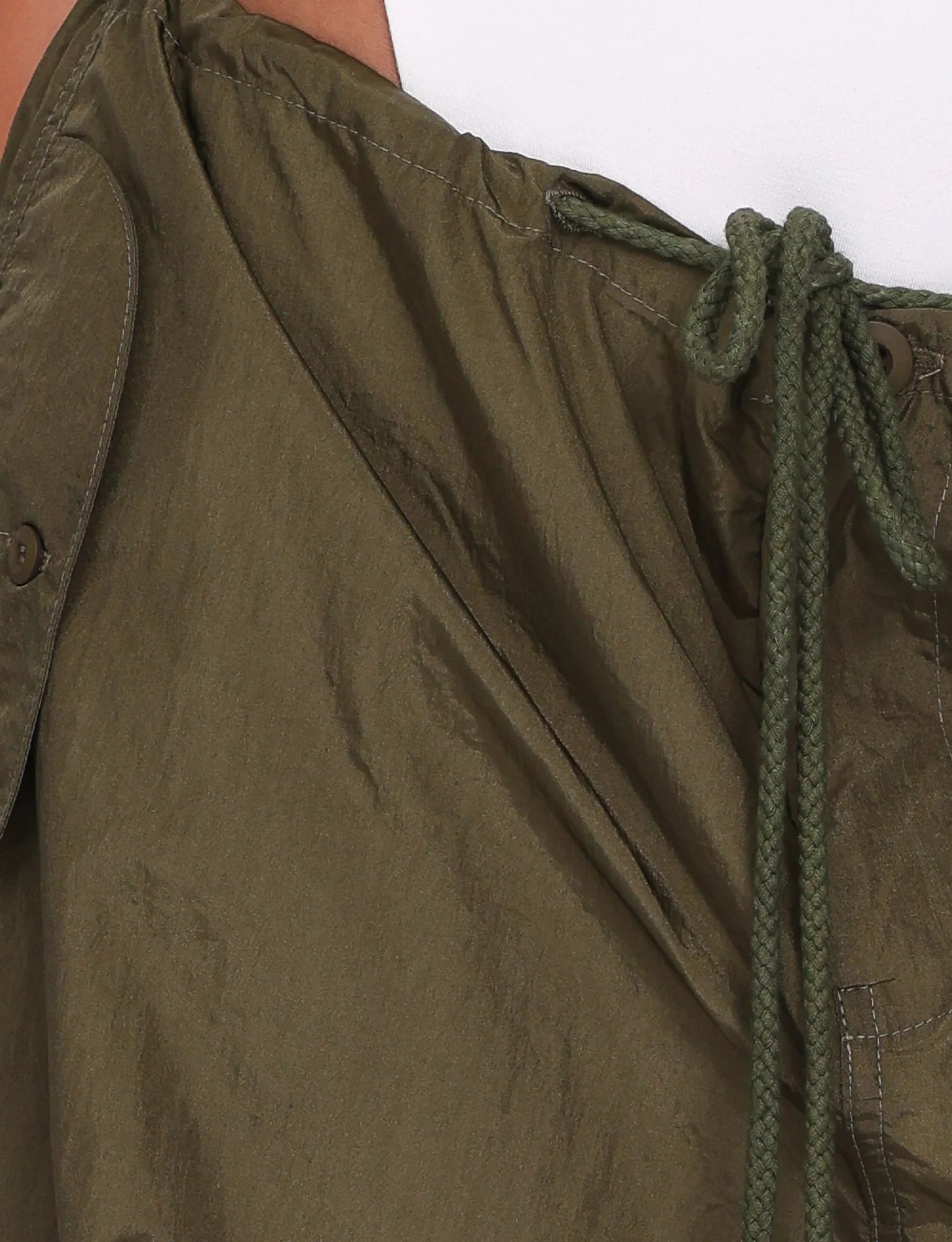 Close-up of a green jacket with a drawstring on a white background