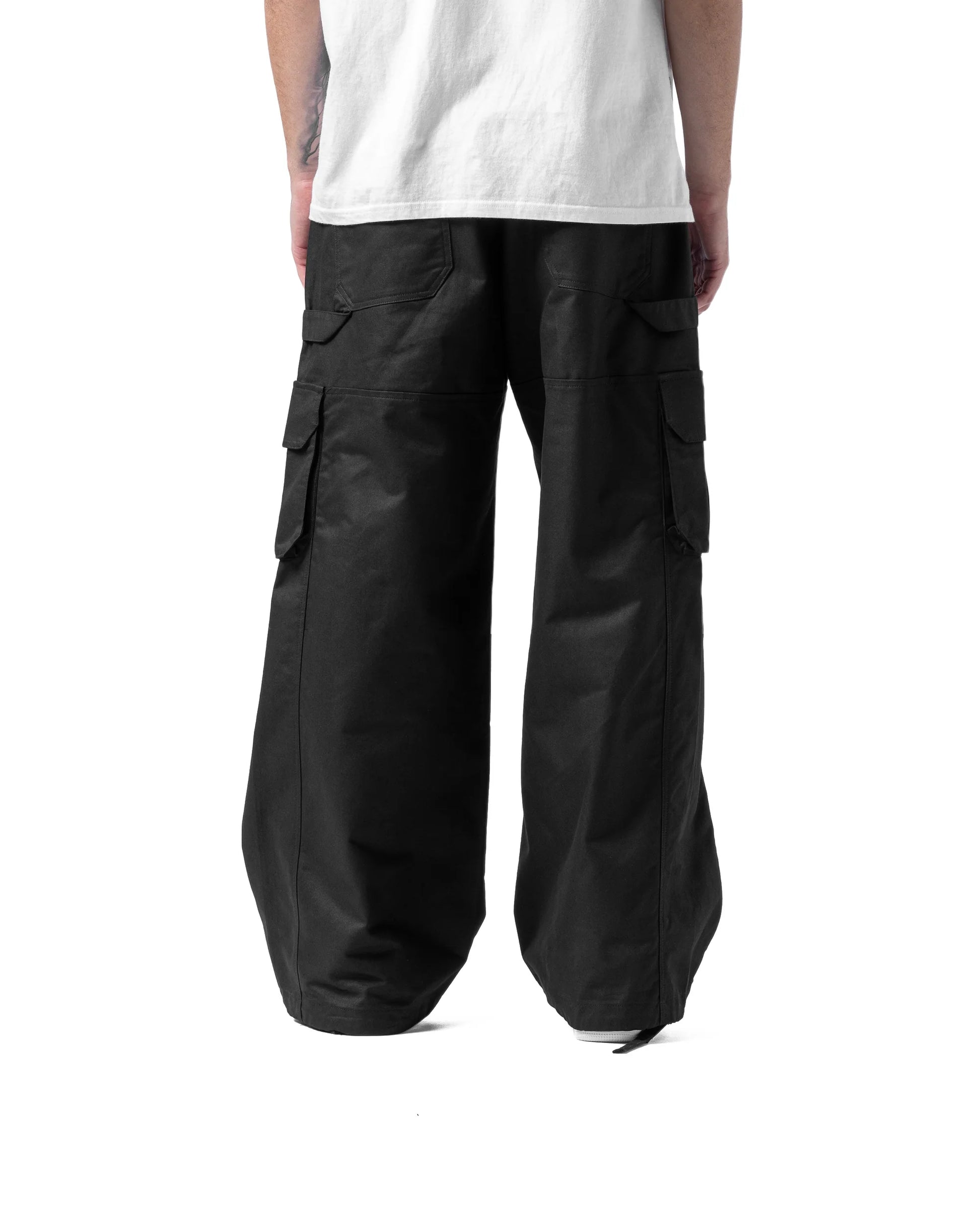 Black cargo pants worn by a person on a white background
