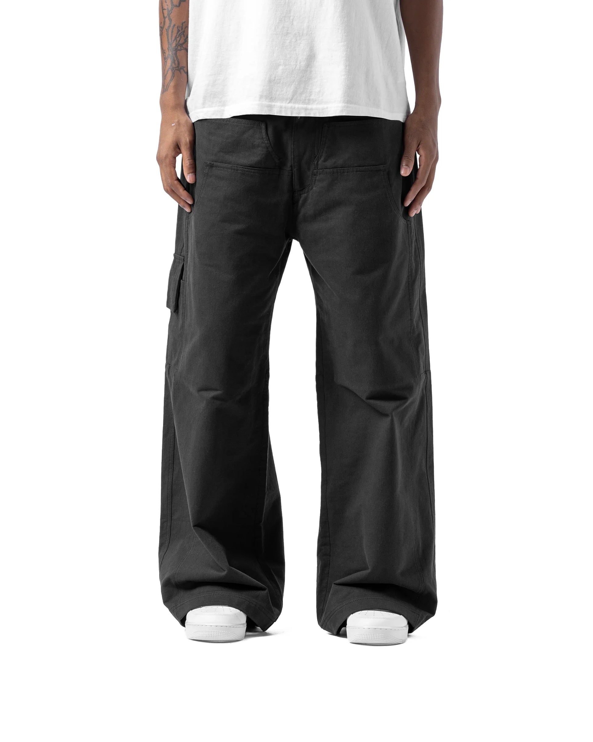 Person wearing black cargo pants and a white shirt on a white background