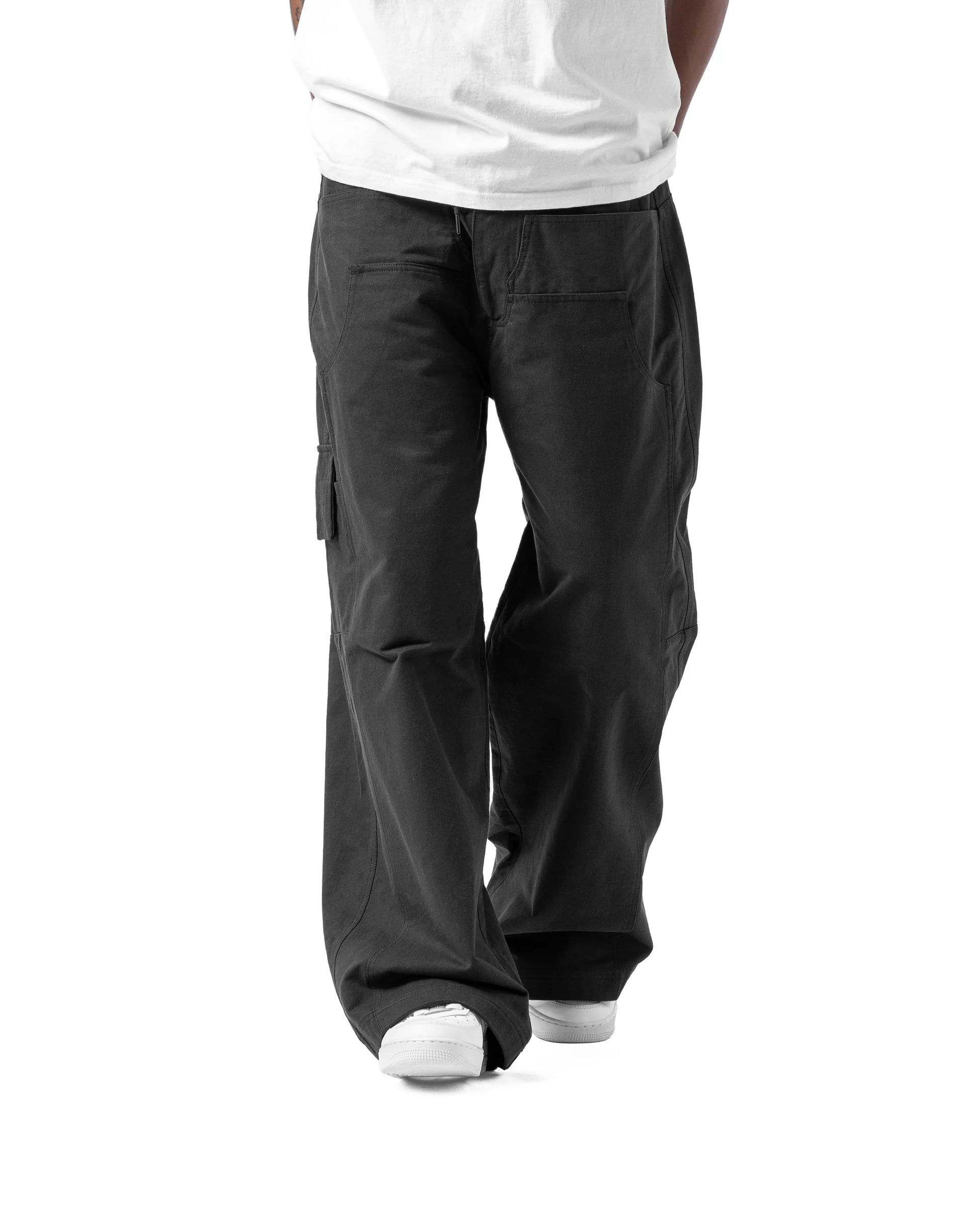 Person wearing black cargo pants on a white background