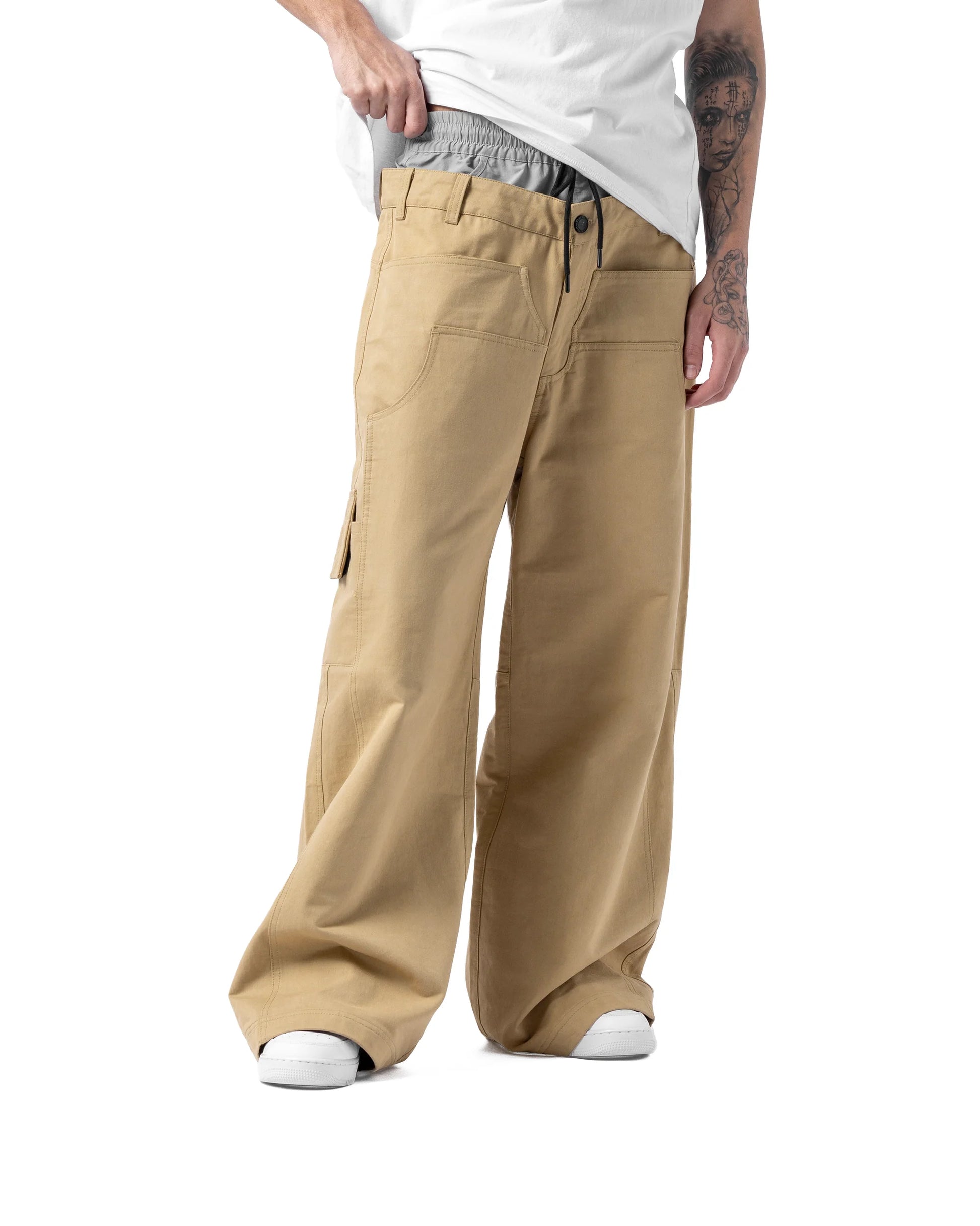 Person wearing beige cargo pants on a white background