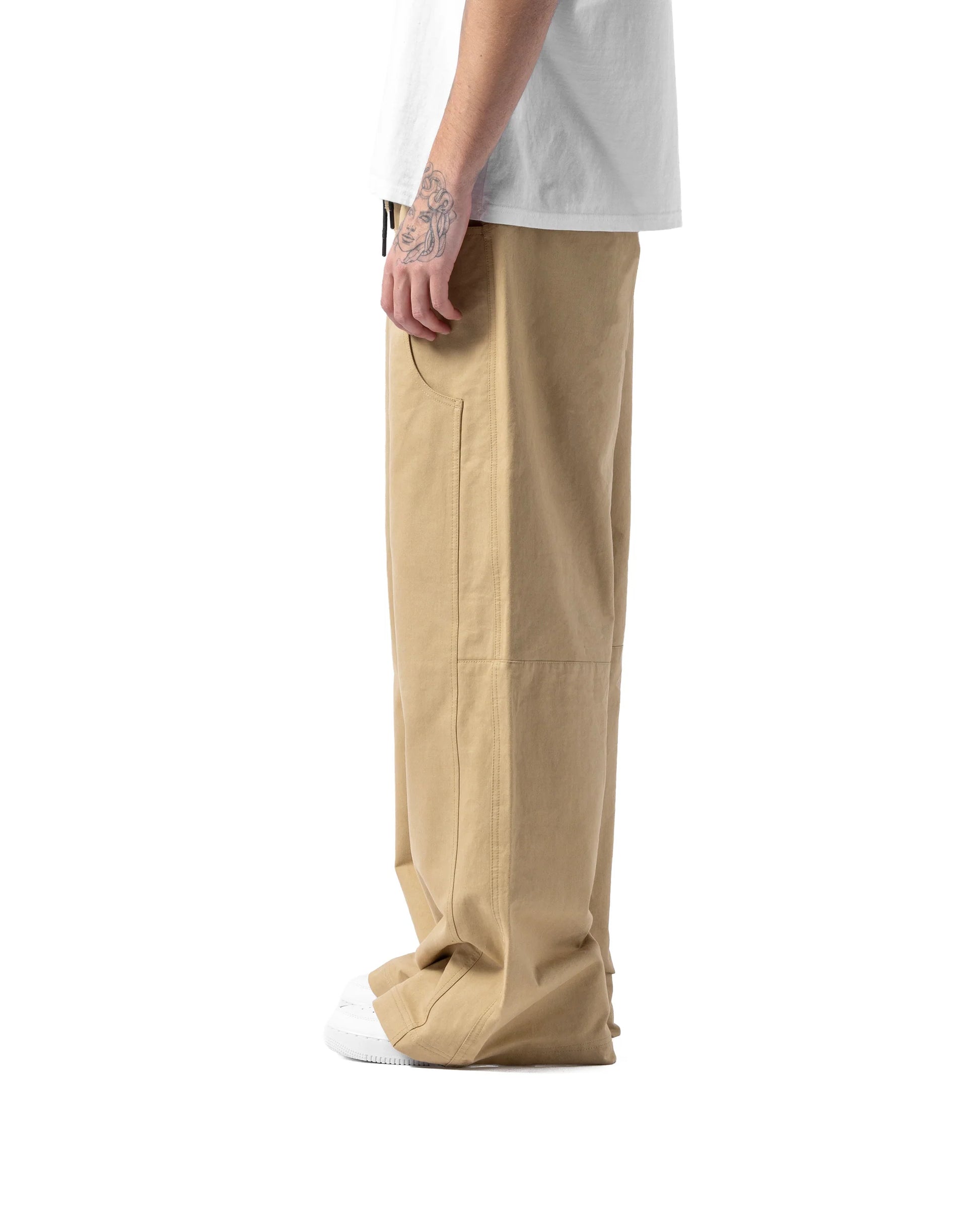Beige cargo pants worn by a person on a white background