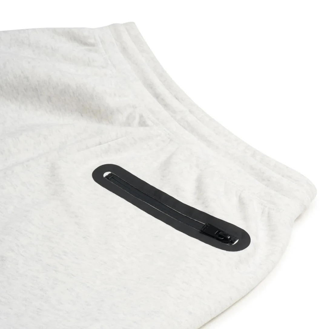 White sweatpants with a black zipper on a white background