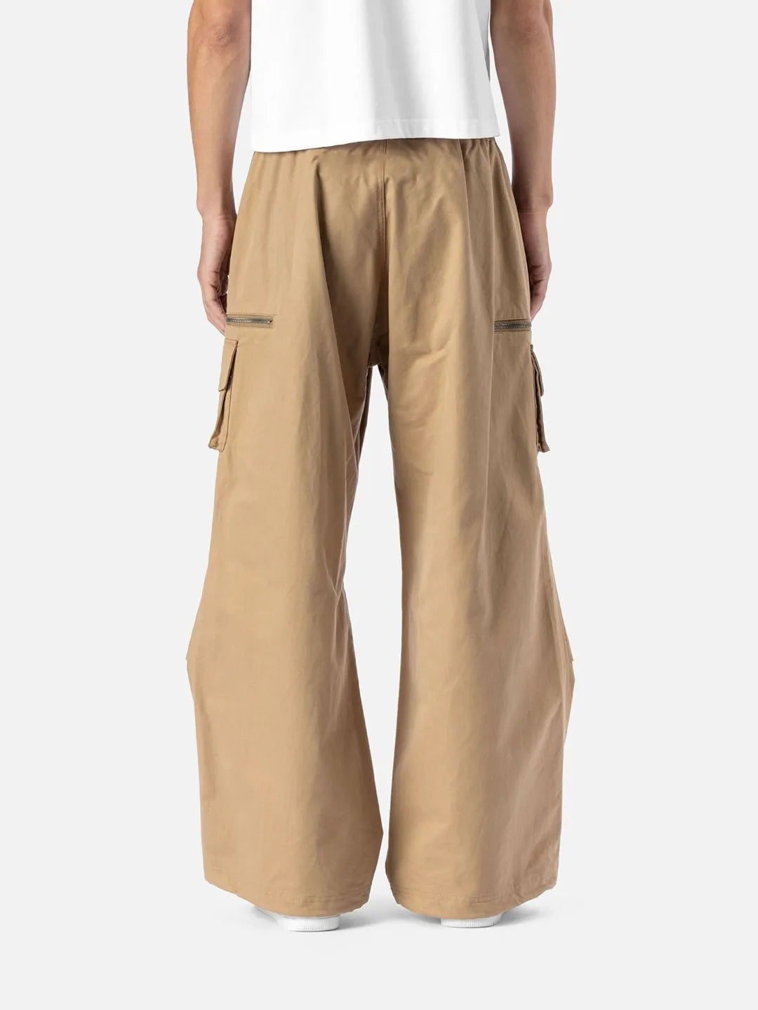 Beige cargo pants with adjustable drawstrings and pockets on a white background