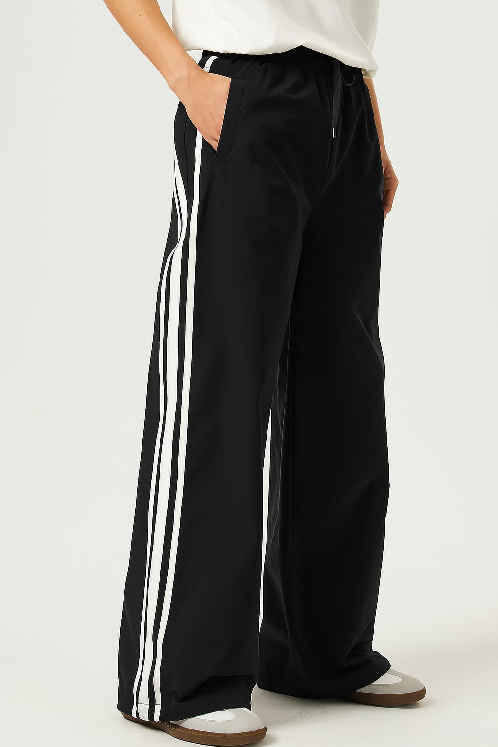 Black pants with white stripes on a white background